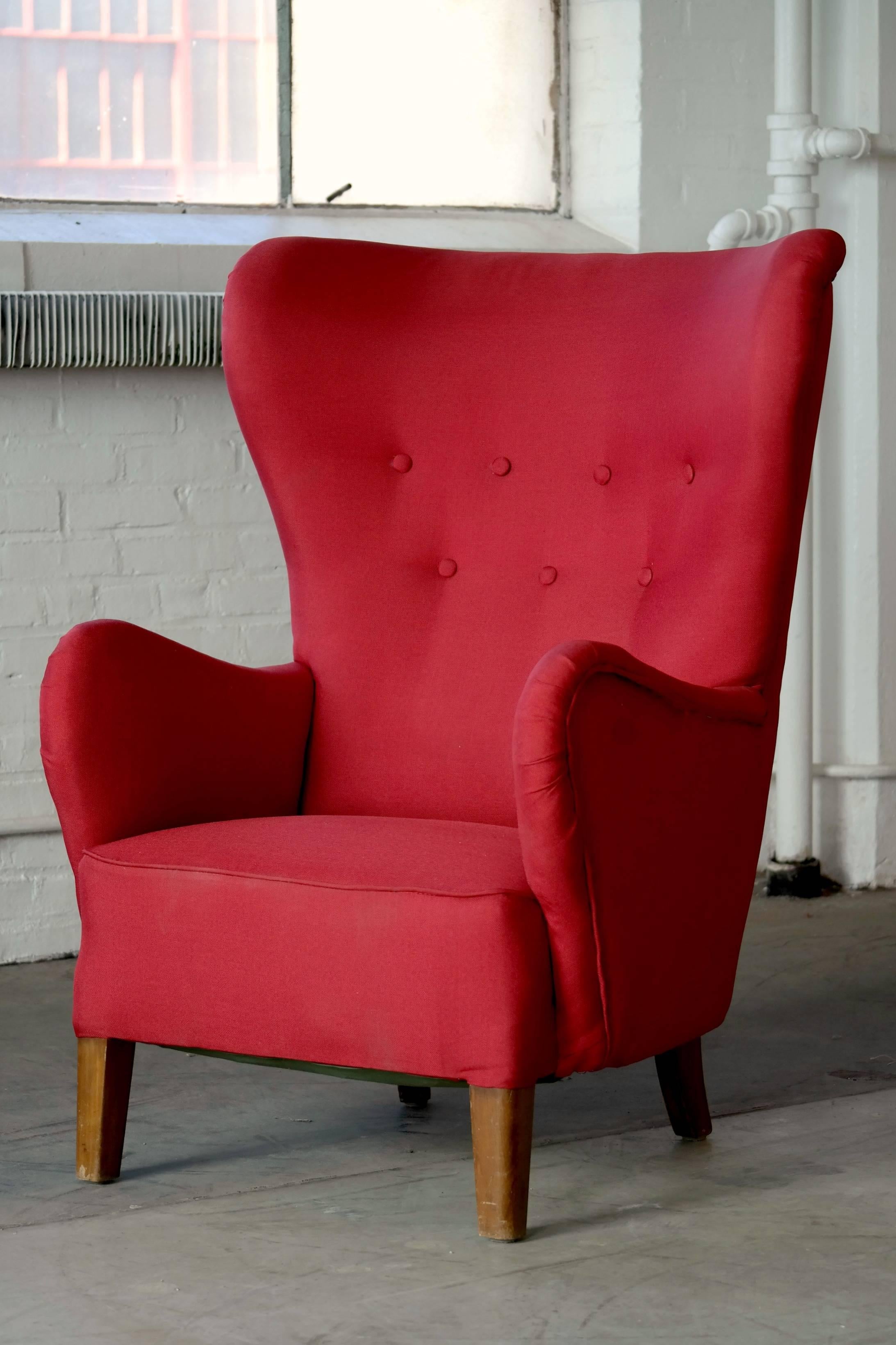 Classic Danish Mogens Lassen style highback armchair from the 1940s. Solid and sturdy construction with a frame and legs of beech wood and recently refurbished and reupholstered in wool.