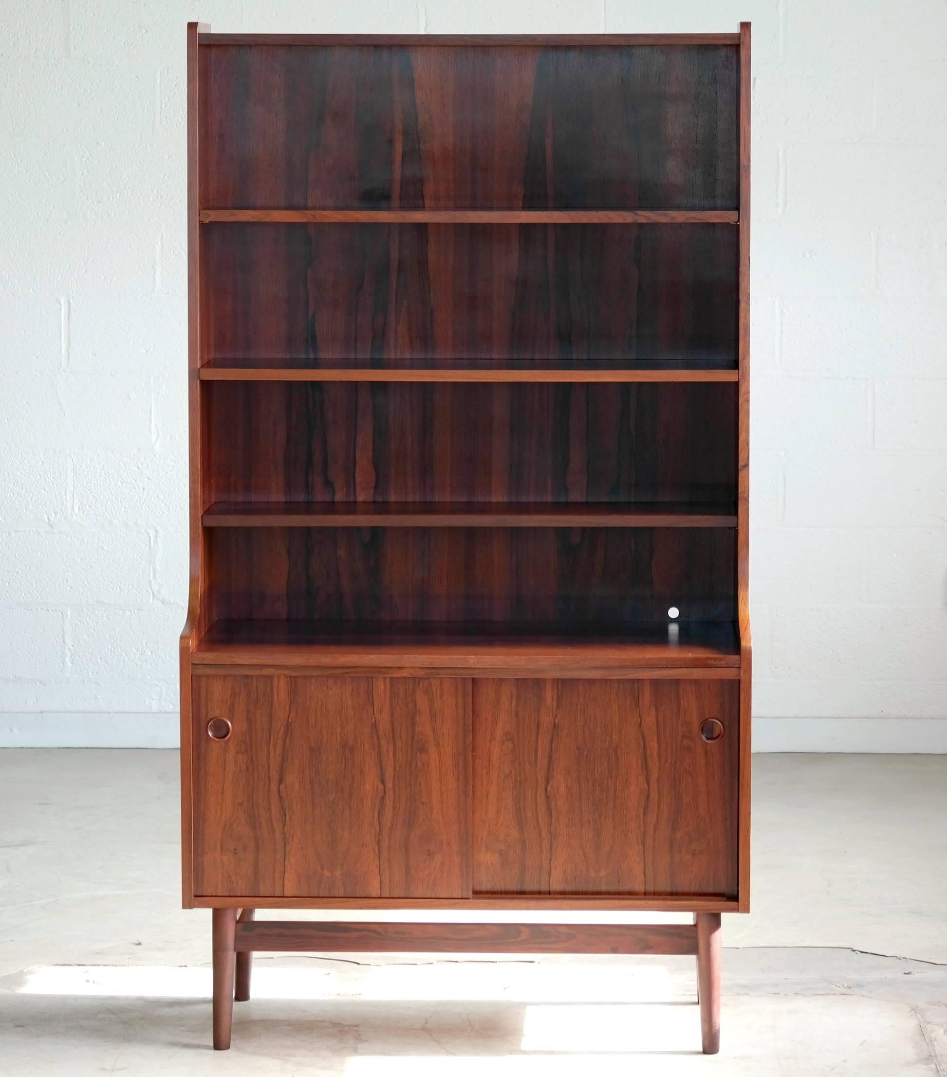 Beautiful rosewood bookcase by Johannes Sorth for Bornholm's Mobler also knows as Nexoe Teak. Very useful with adjustable shelves and two storage cabinets underneath. These bookcases are becoming increasingly sought after as Mr. Sorth's designs keep