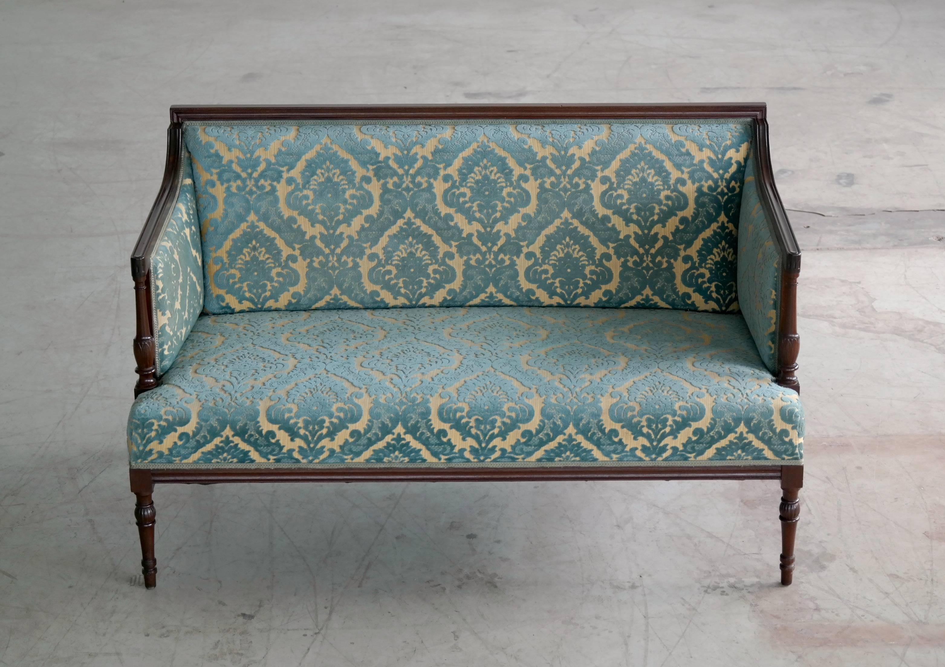 Very rare Sheraton-style settee by the Master cabinet maker Georg Kofoed. Turned front legs and profiled edges. All mahogany in very good to excellent condition. Danish elegance and charm at its best.
  