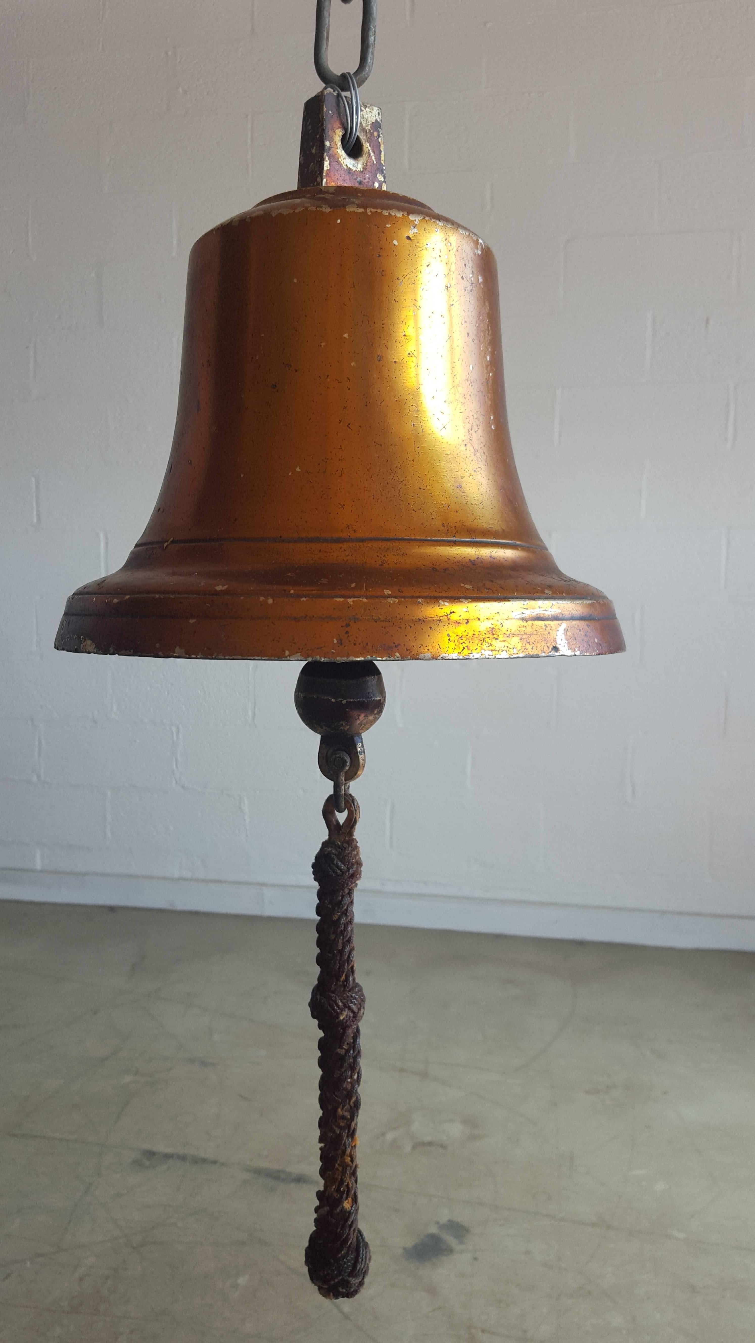 Very nice original Danish ships bell in brass made circa 1930s as far as we can judge. The bell has at a point in time been given a coat or two of boat varnish which the sun, salt, water and wind have turned into an amber colored glaze adding