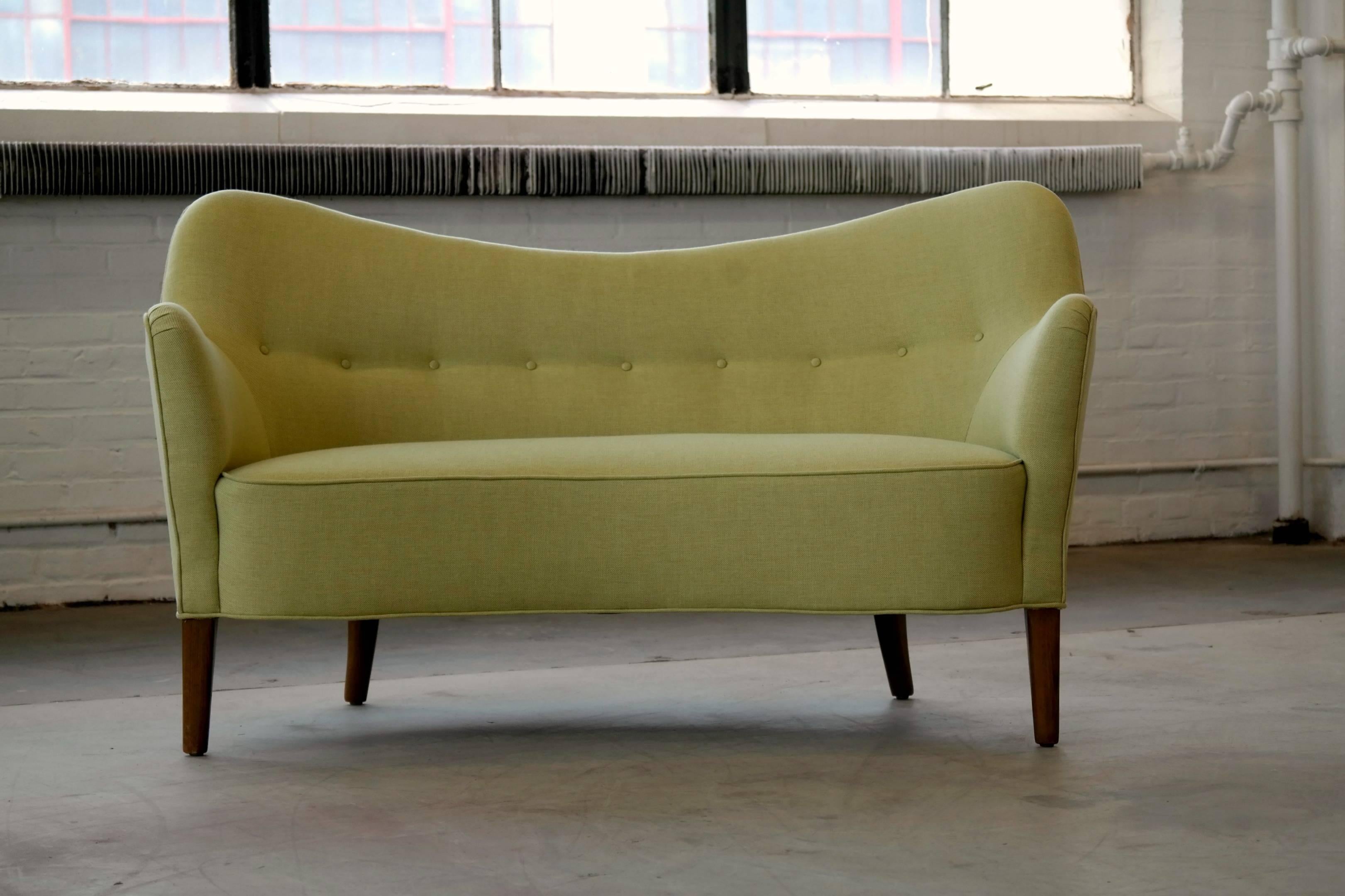 Superbly elegant Finn Juhl attributed petite sofa or settee model 185 made by Slagelse Mobelvaerk, Denmark. The lines and proportions of this design are just perfection. While rare this sofa is often sold as a Finn Juhl model BO-55 designed by Juhl