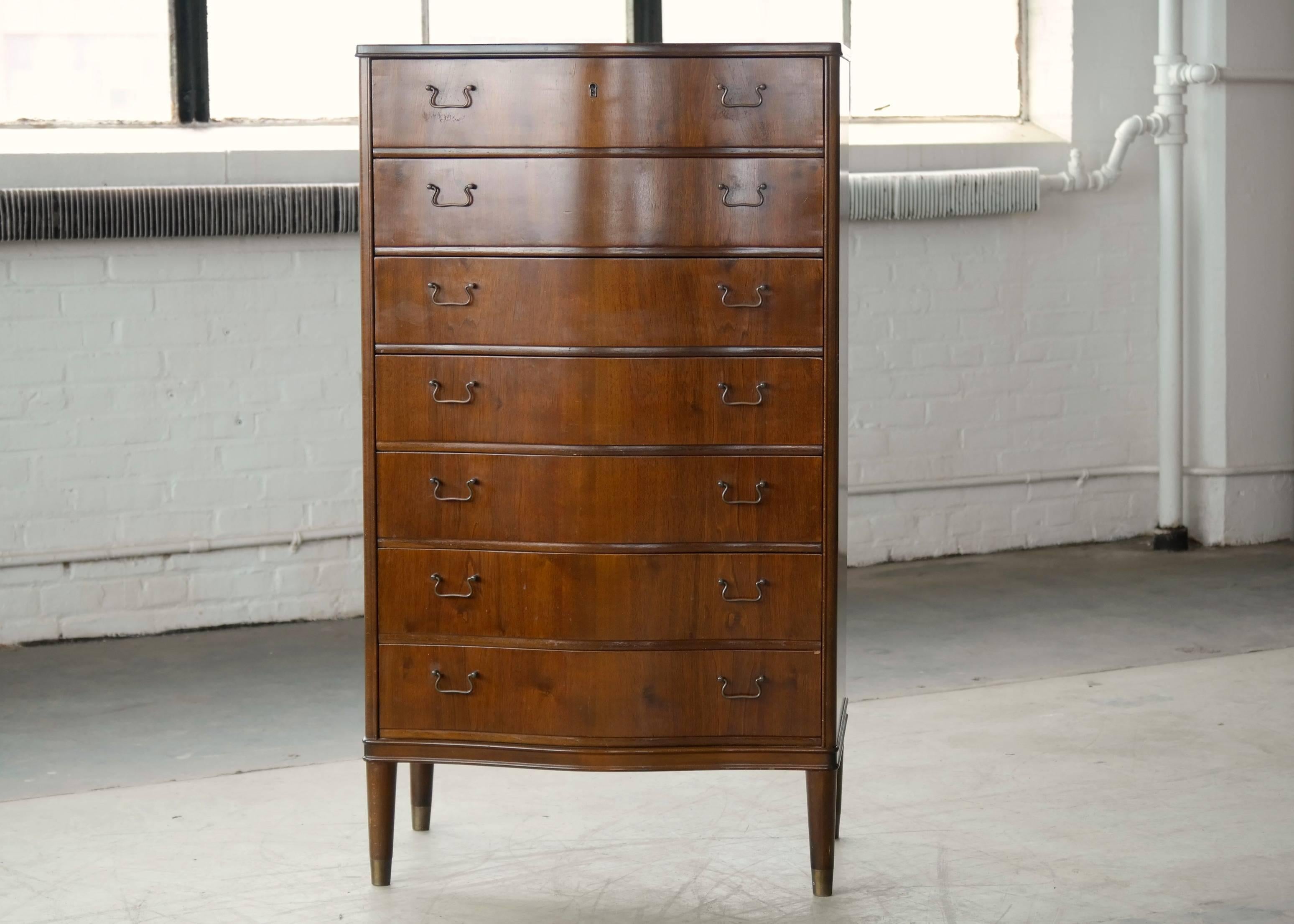 Ultra stylish dresser in walnut with brass pulls. Made in Denmark in the 1950s very much in the style of Frits Henningsen. Overall very good condition showing only minor age appropriate wear.

 