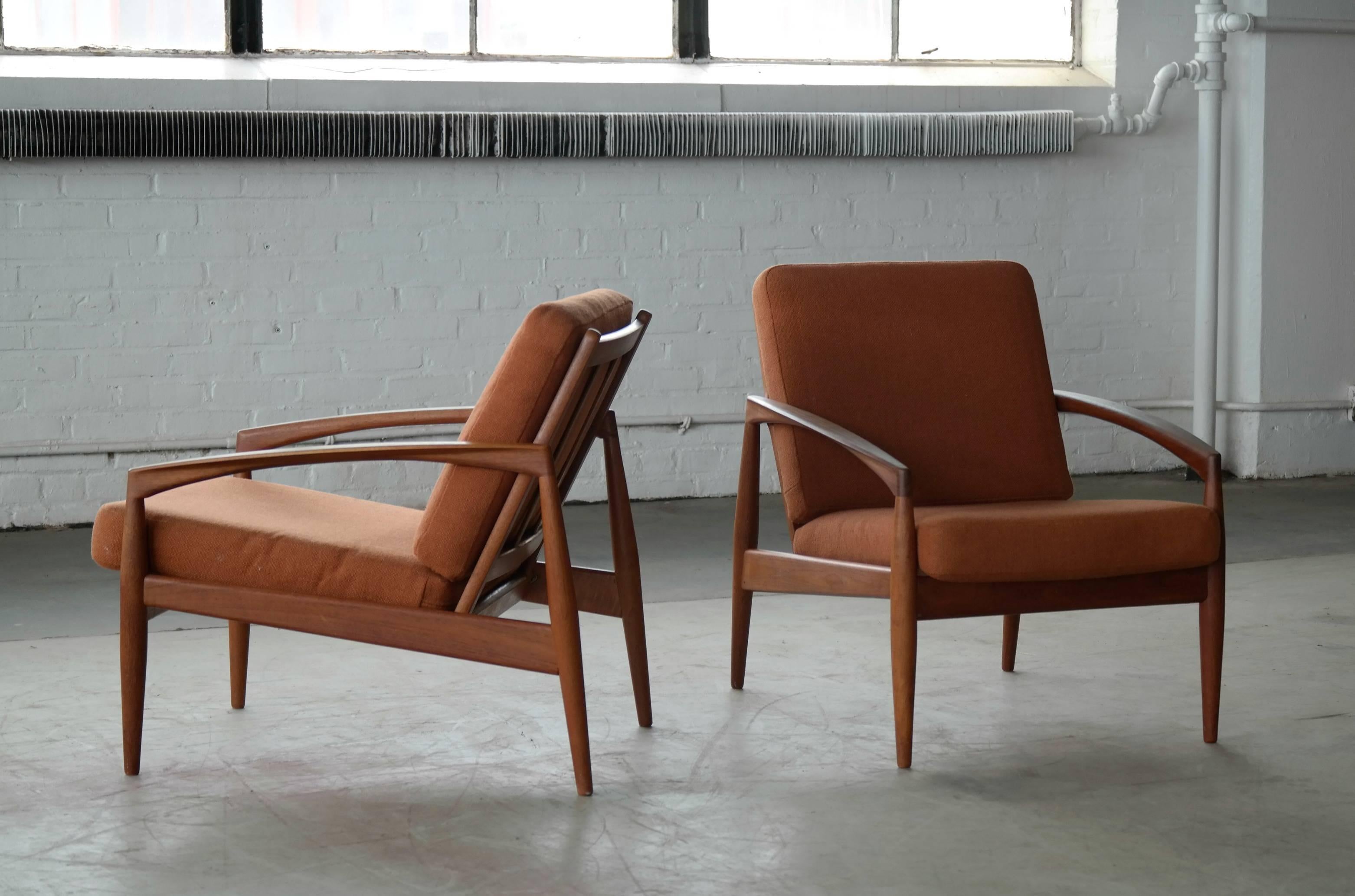Beautiful pair of Model 121 known as the Paper Knife teak easy chairs by Kai Kristiansen manufactured by Magnus Olesen, Denmark. Made of solid teak wood and is of superb quality. Great clean lines and amazing details. The chairs still have their