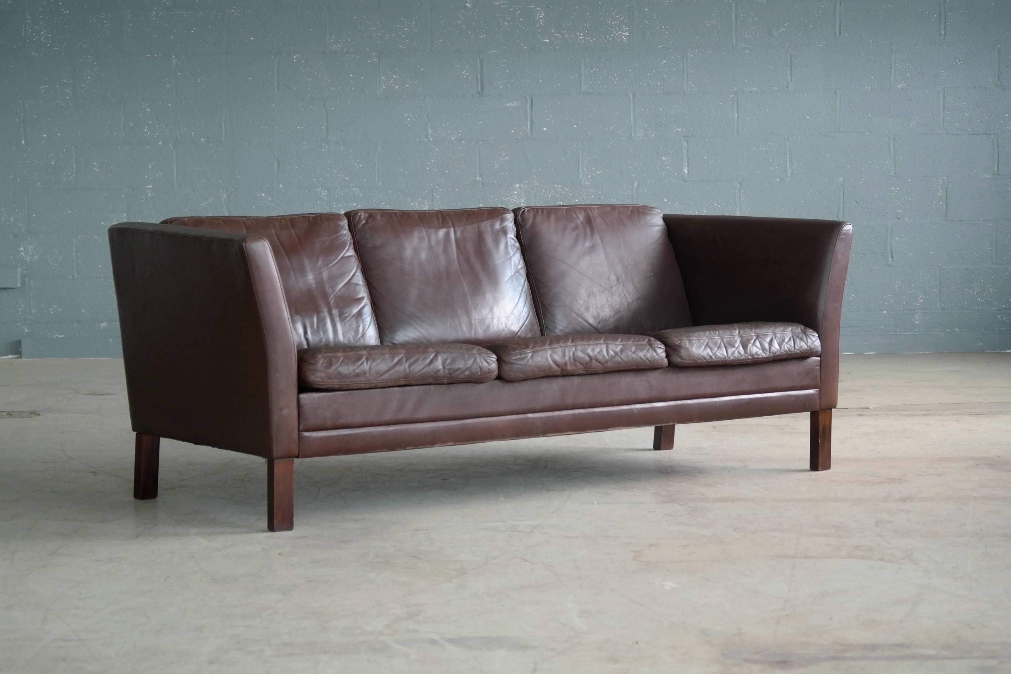 Great Borge Mogensen style sofa in supple chocolate colored leather by Mogens Hansen. Designed in 1971 and likely manufactured sometime in the 1970s. Nice patina with some minor scuffing and scratches. Classic Danish.