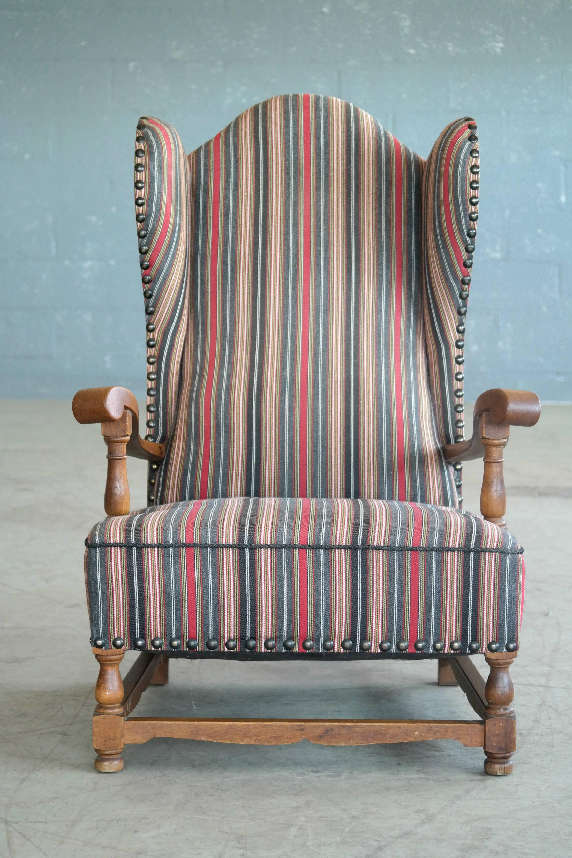 Great example of early Danish Mid-Century design, circa 1930s wingback chair in oak. Fantastic addition to the country home or the library. Fully refurbished and sturdy construction recovered in high quality striped wool. Minimal age wear and patina