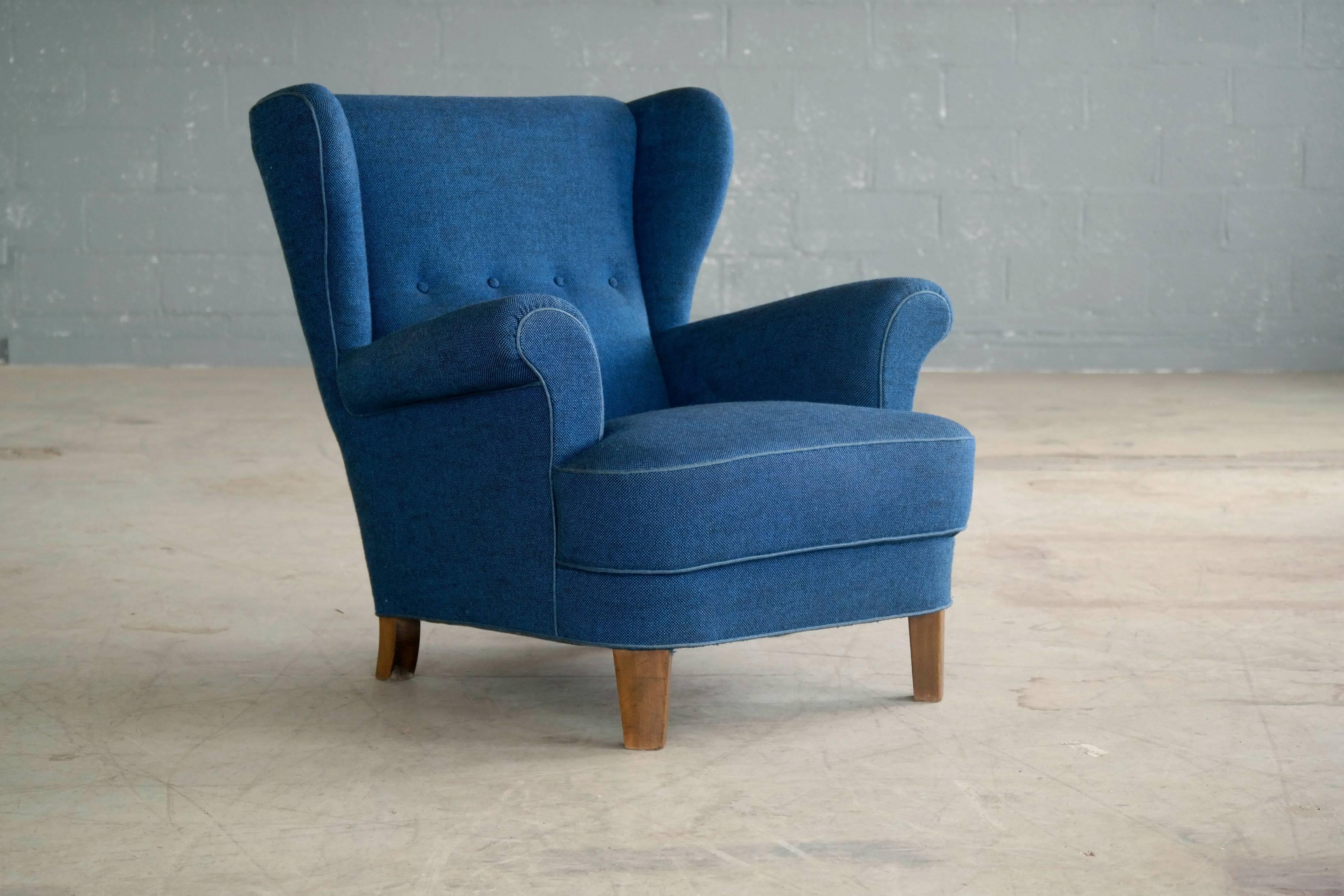 Beautifully proportioned 1950s armchair with a beechwood frame on Mahogany legs. Later re-upholstered in a vibrant blue Hallingdal wool fabric by Kvadrat. Impressive with great presence and superbly comfortable. Excellent overall condition.
