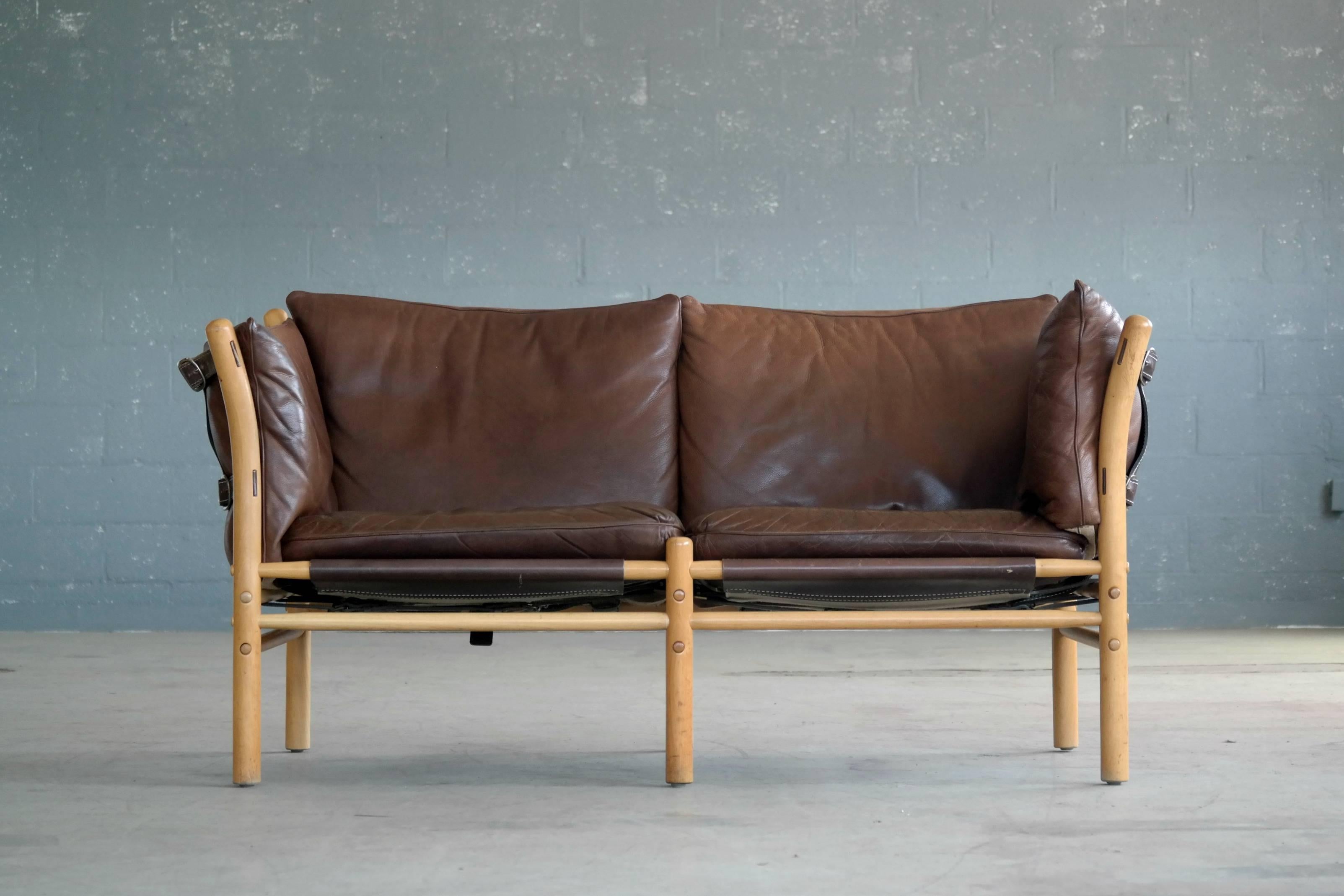 Beautiful 1960s safari-style sofa by Arne Norell in beech and leather. The leather has patinated to a deep cognac leather which stands in perfect contrast to the blond beechwood frame. A little bit of crazing to one of the seat cushions but great
