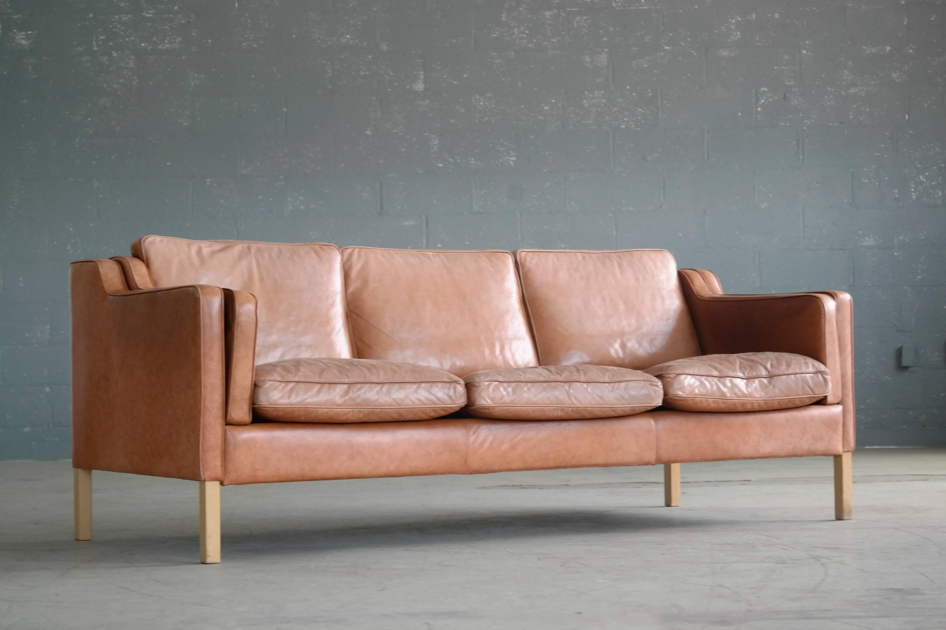 Classic Børge Mogensen model 2213 style London sofa in light cognac colored leather by Stouby Mobler and designed in 1968. Highest quality craftsmanship upholstered in aniline leather. Some sun fading of the color and just the right amount of patina