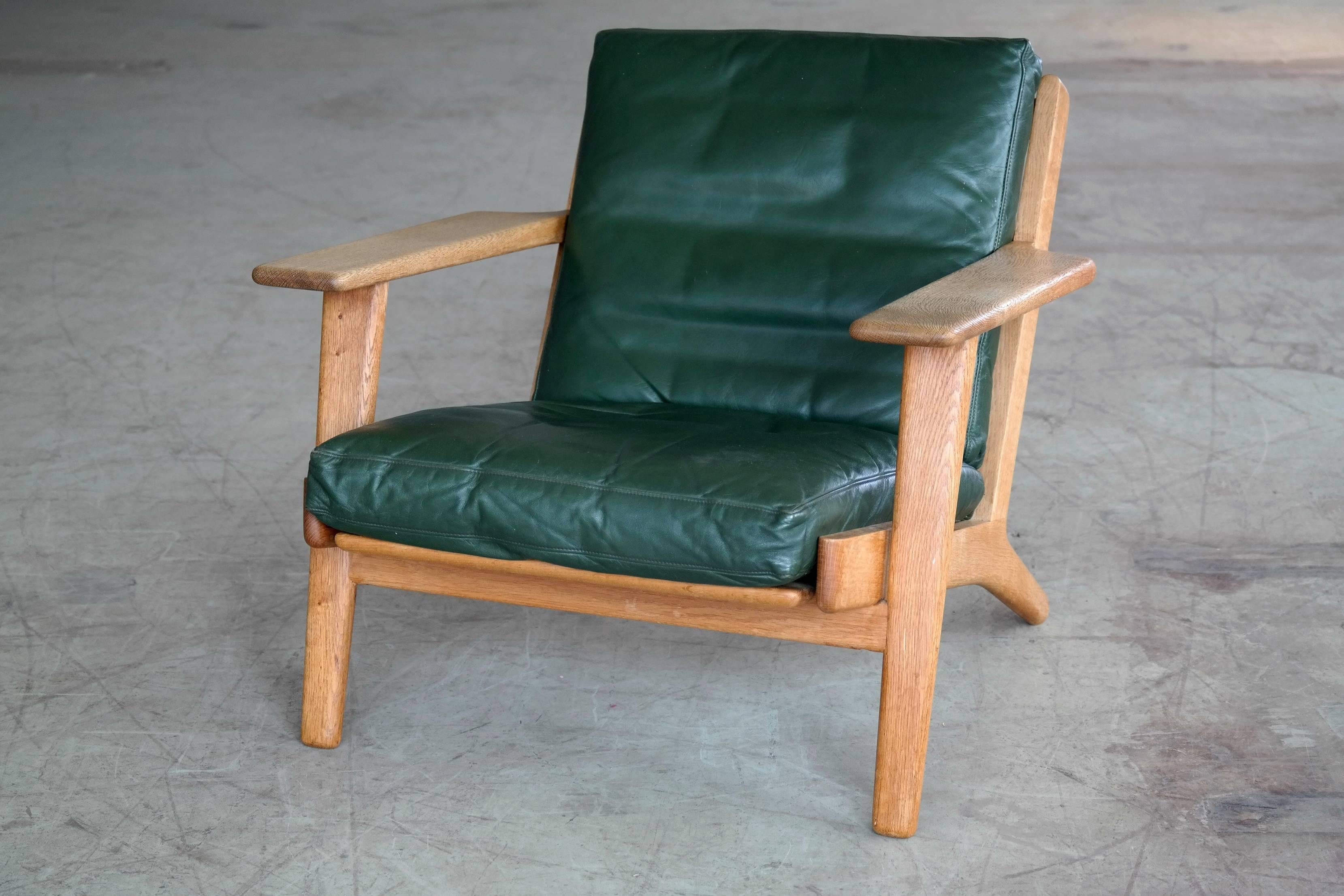 Sought after low back lounge chair model GE290 designed by Hans Wegner for GETAMA in 1953. The GE290 his is one of Wegner's most iconic designs with its solid oak frame, splayed legs and distinctive paddle armrests. This version upholstered in