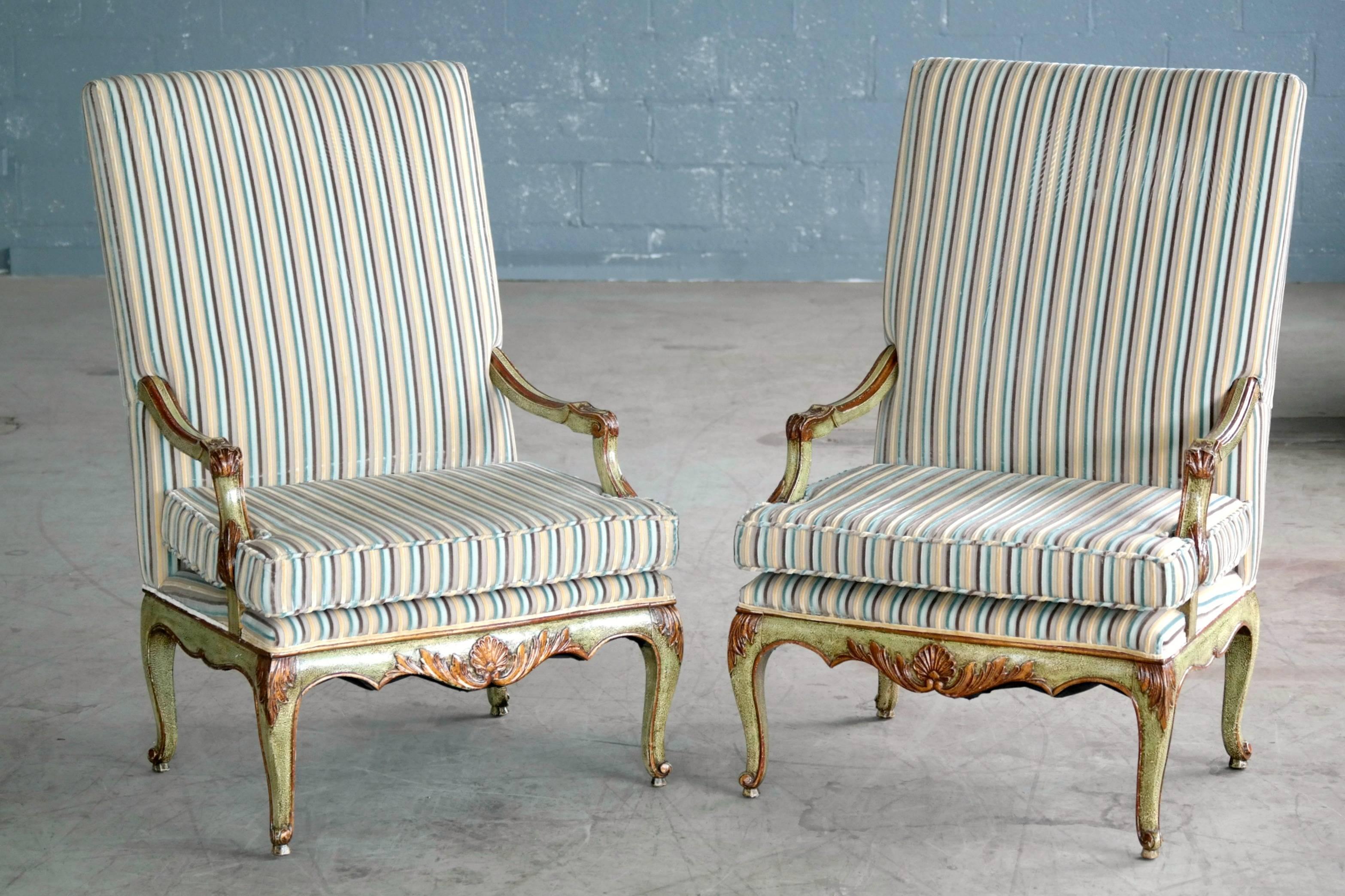 Excellent pair of hand-carved and painted high back Danish armchairs in the Regency style made circa 1900. Recently refurbished and upholstered in a striped velvet. Excellent condition.

