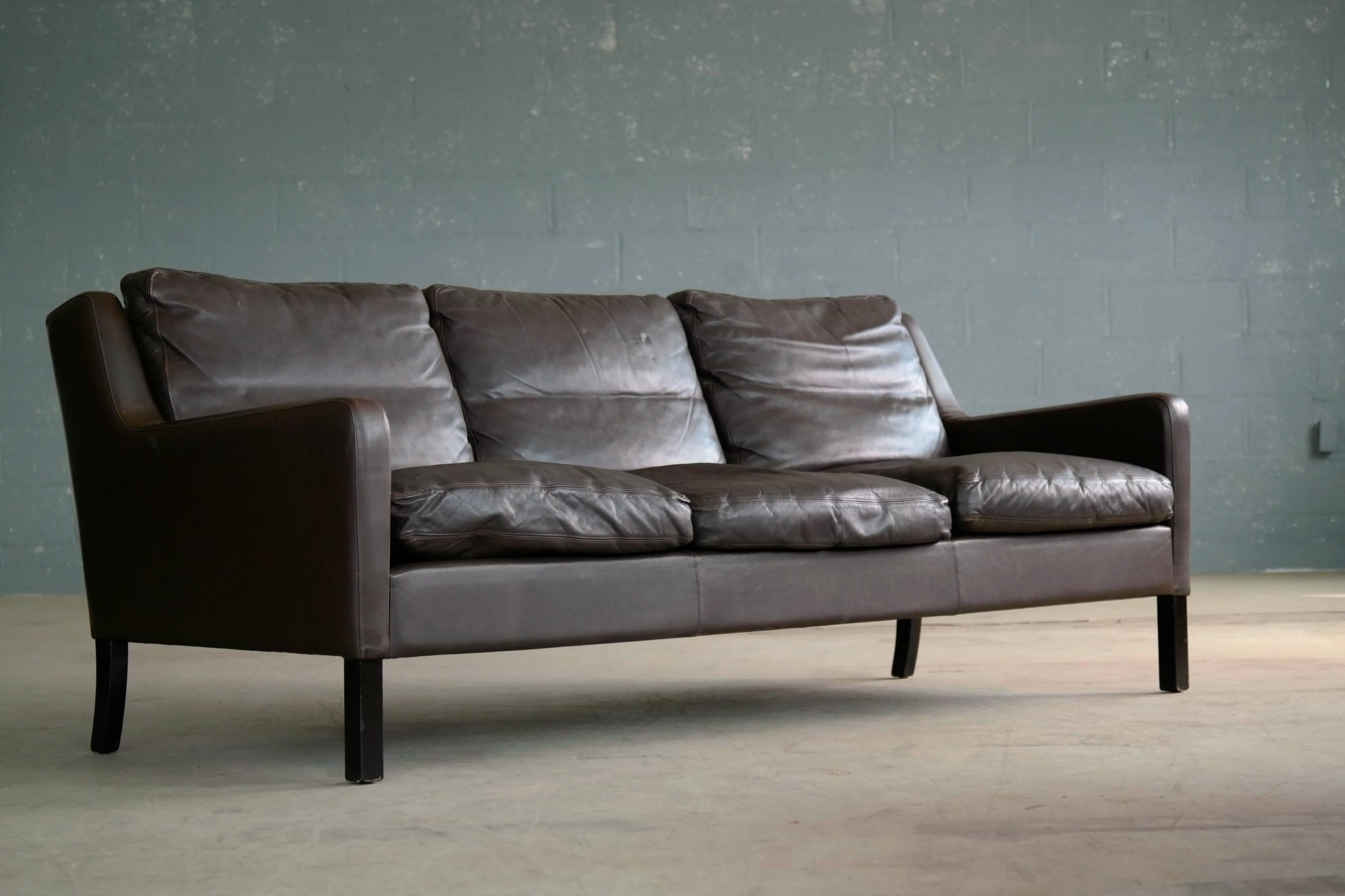 Great Børge Mogensen style sofa designed by Georg Thams in the 1960s and manufactured by Vejen Polstermoblefabrik, Denmark. High quality craftsmanship in nice mocha colored leather with nice wear and patina. Cushions top filled with down. Legs of