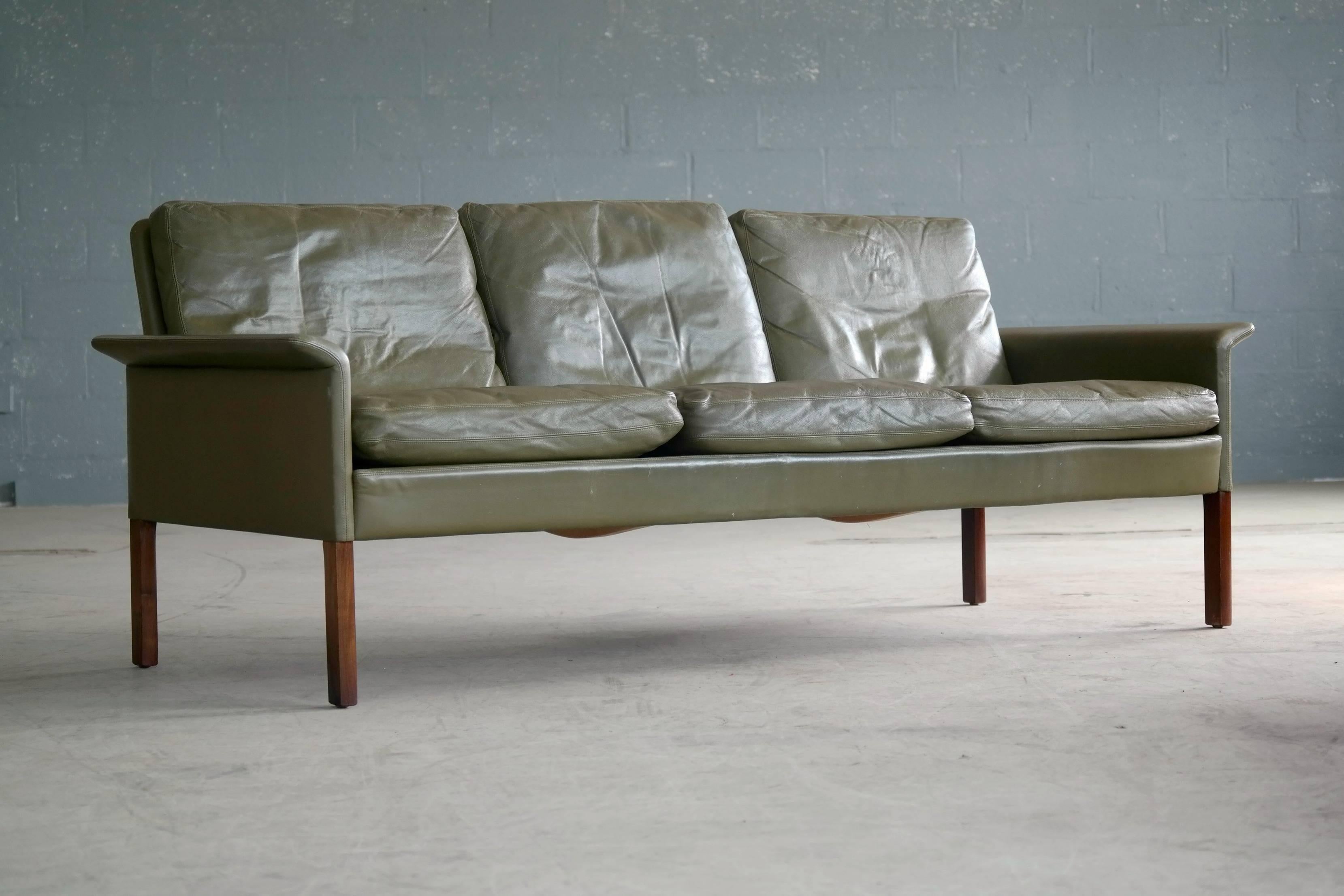 The ultimate style and the color of green written all-over it. Classic three-seat sofa designed by Hans Olsen in the 1960s for CS Mobler in Glostrup, Denmark. Covered in supple top grain leather in a very attractive hard to find green color with the