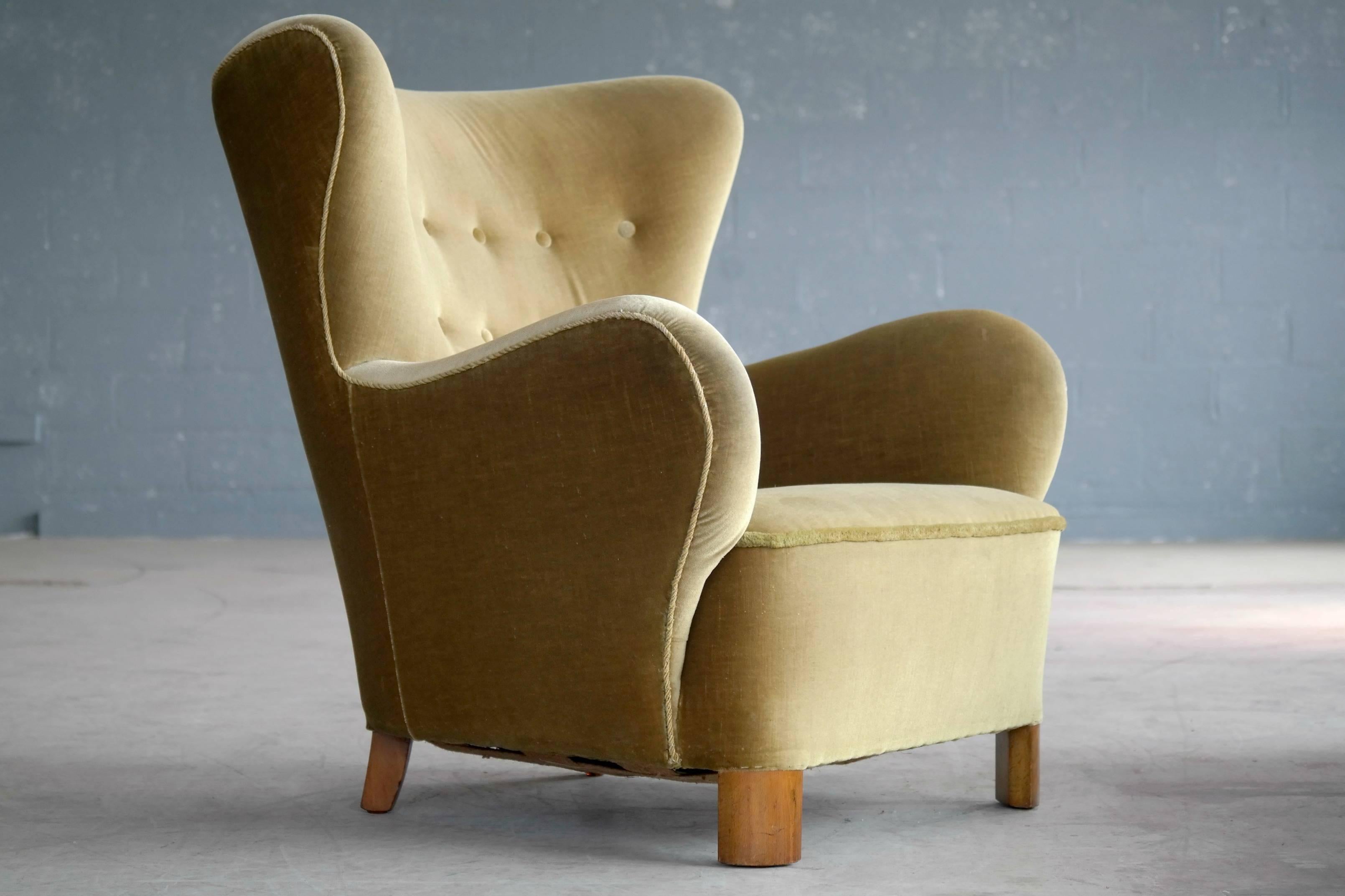 Fantastic Flemming Lassen style armchair with a yellowish brown mohair fabric. The chair has all the right design cues in regards of being a Lassen chair except for the front legs that are slightly thicker than for is generally accepted as Lassen.