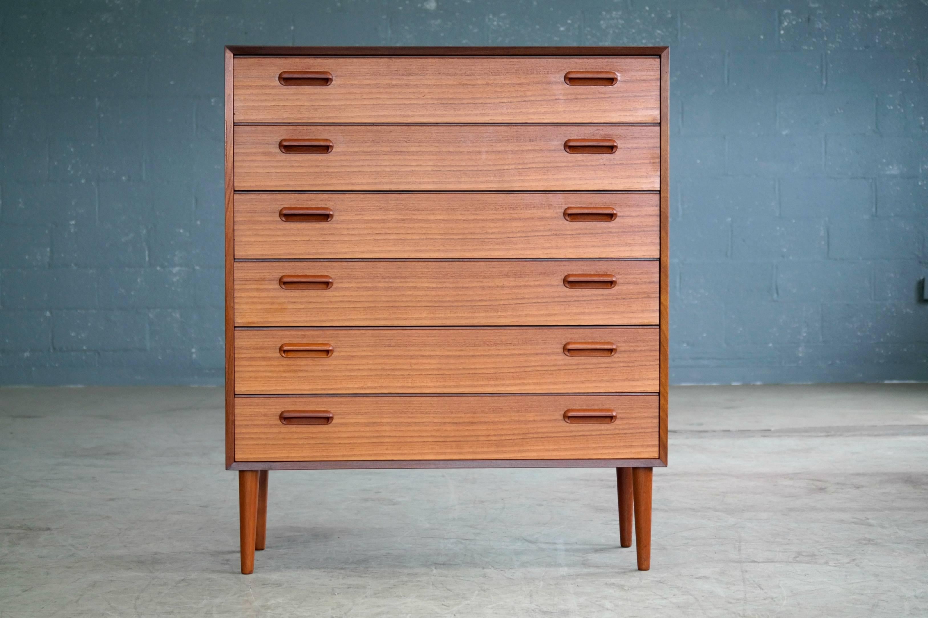 Super elegant tallboy dresser in the style of Ib Kofod-Larsen. Kofod Larsen very much liked sharp simple yet very elegant lines and also preferred to cut the grains so they would run in a horizontal pattern on the front of the drawers. Further, he
