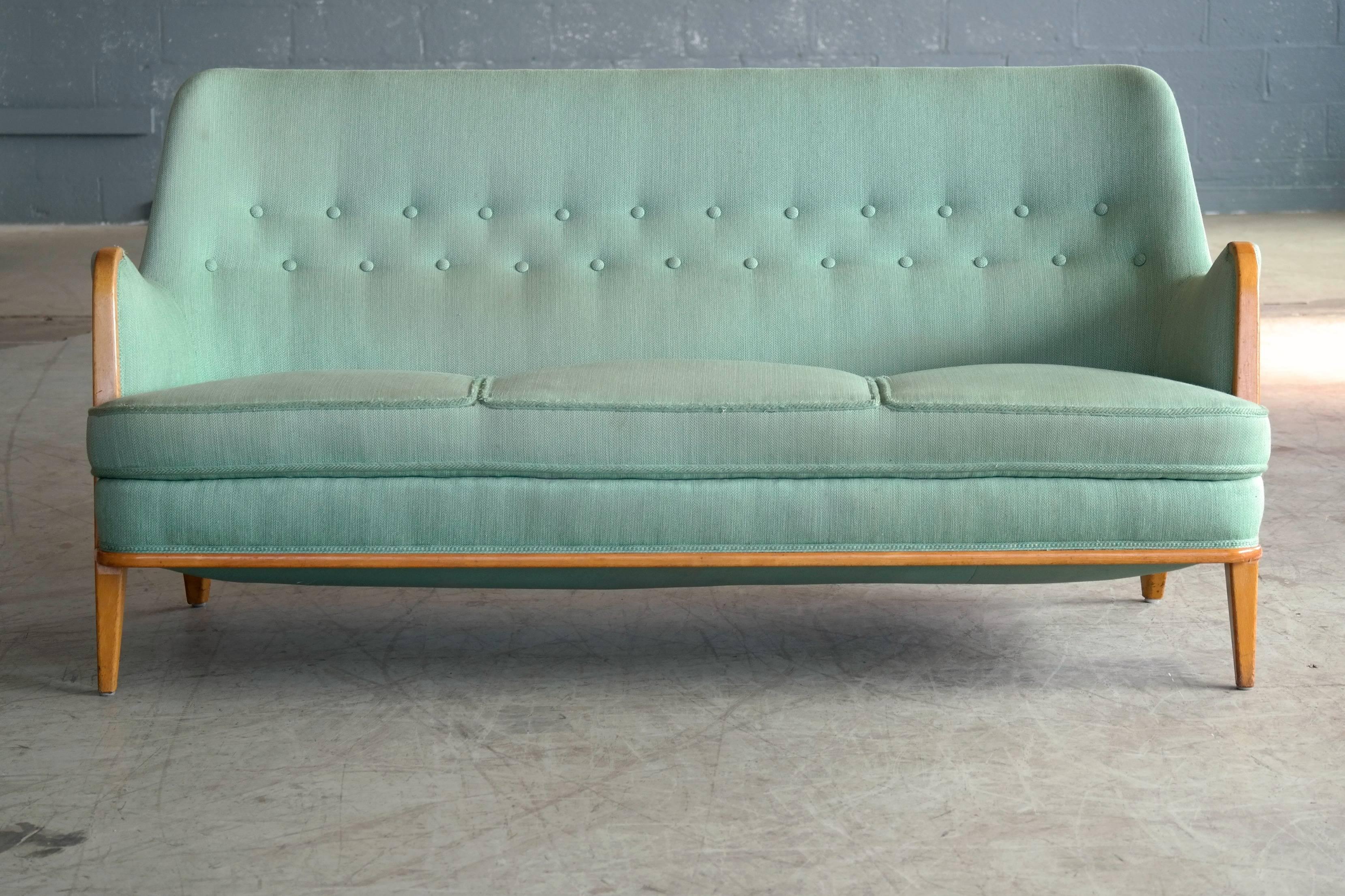 Exquisite sofa designed by famed Axel Larsson in Sweden in the 1940s. While the design is unmistakably Larsson we cannot be sure of the maker of this unmarked piece but similar pieces from the period are often attributed to Master Carpenter, Hjalmar