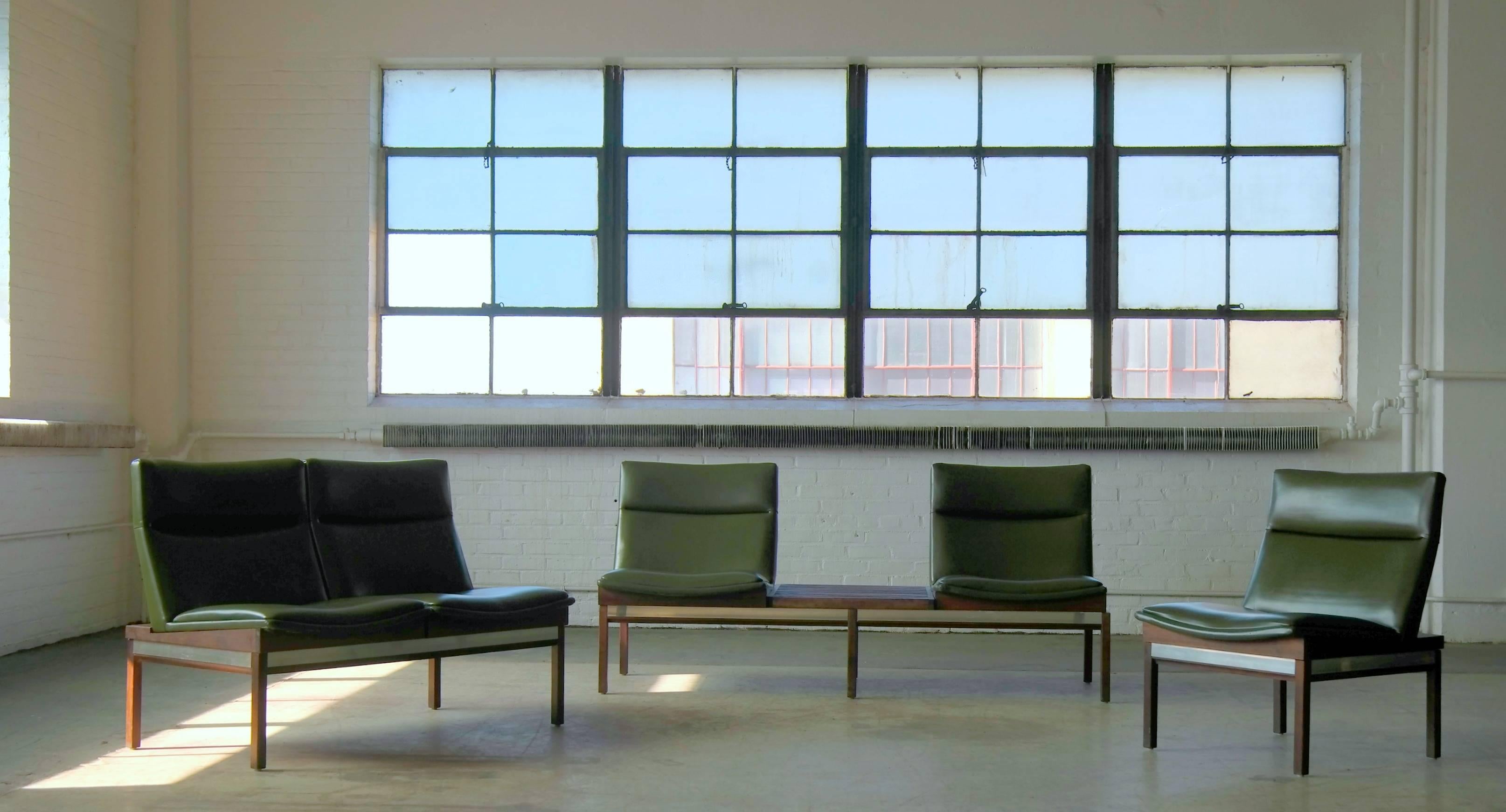 Ultra cool modular sofa set with two-seat sofa and a lounge chair and a two-seat sofa with built in table in walnut with aluminum accents and covered in green Naugahyde designed by Arthur Umanoff in the 1950s for Madison Furniture Industries.