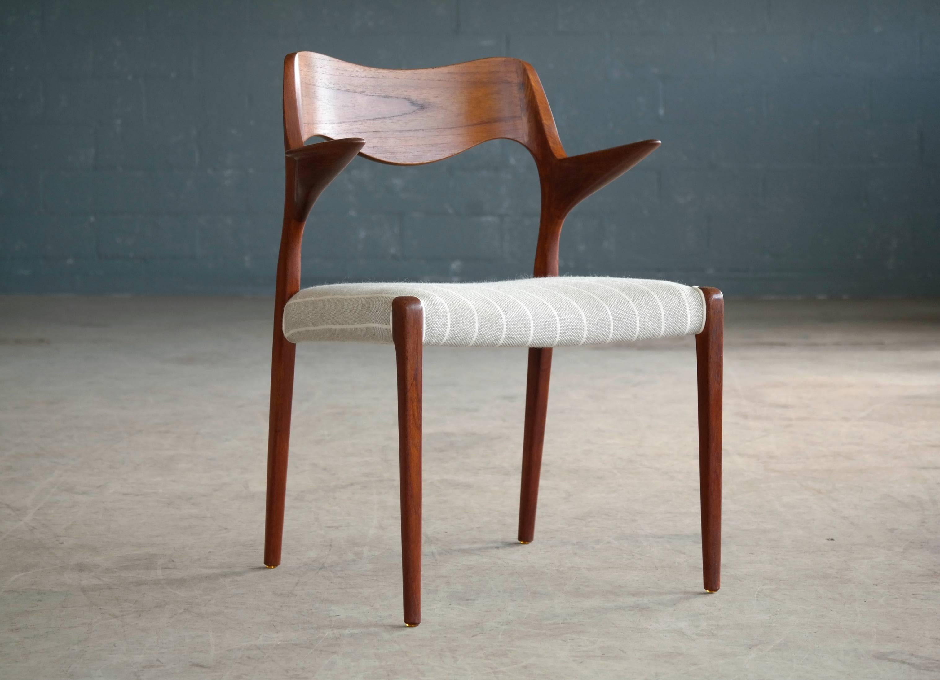 This wonderful Danish modern teak armchair by NO Moller was designed in 1955 for J.L. Møllers Møbelfabrik. Beautiful versatile chair that works equally well as a work chair with your desk or at the helm of the dining table. Beautiful hand-carved