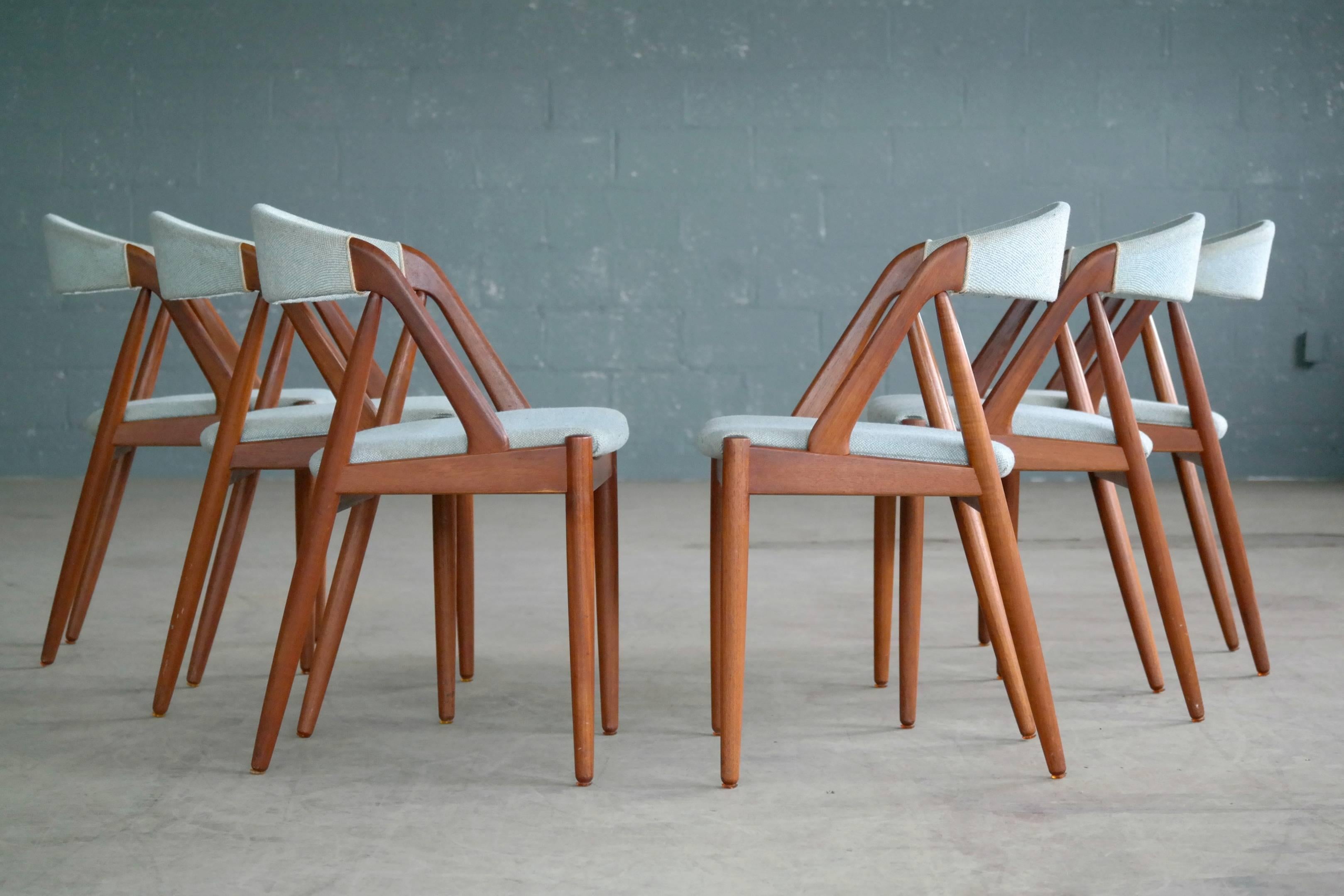 Set of six of one of the most sought after classic dining chairs designed by Kai Kristiansen in 1956 for Schou Andersen Møbelfabrik in Denmark. Made with a solid teak frame the chairs still have their original seat covers which need to be