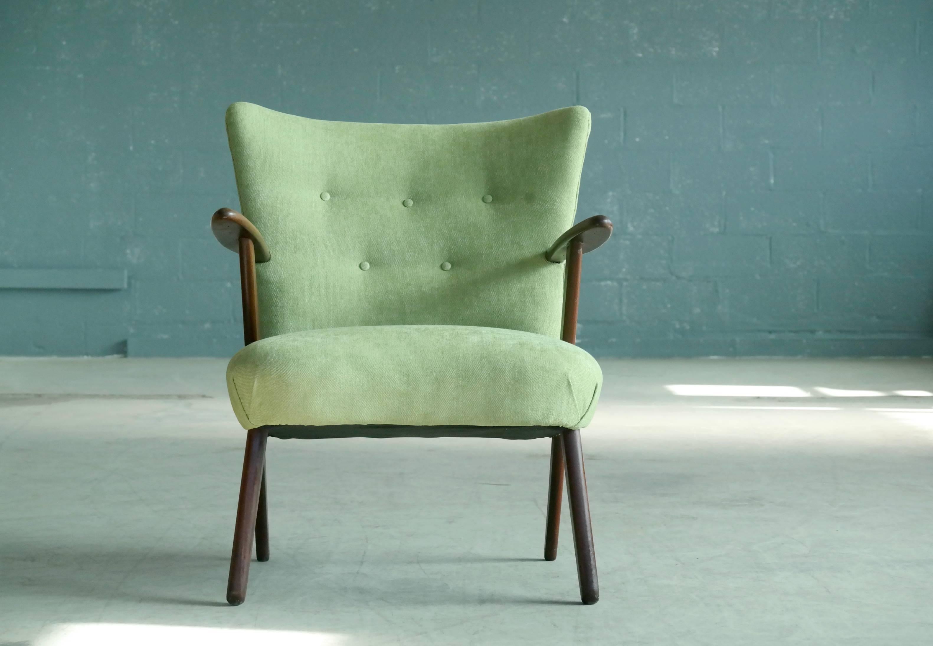A very cool Danish lounge or cocktail chair from the 1950s in the style of Kurt Olsen. Beautiful wood grain and well crafted sturdy construction yet comfortable and light weight. Newly upholstered in a fresh lime green color, great accent chair for