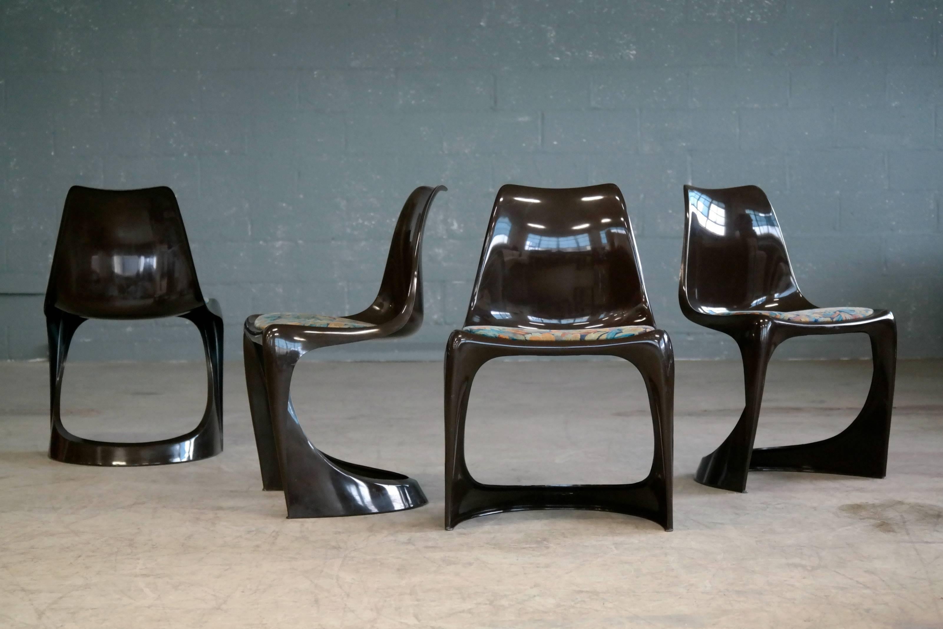Set of four ultra cool dining chairs Model 290 in brown molded plastic designed by Steen Østergaard for Poul Cadovius in 1966. The chairs are stackable and were made to be a perfect match to a series of aluminum dining tables also produced by