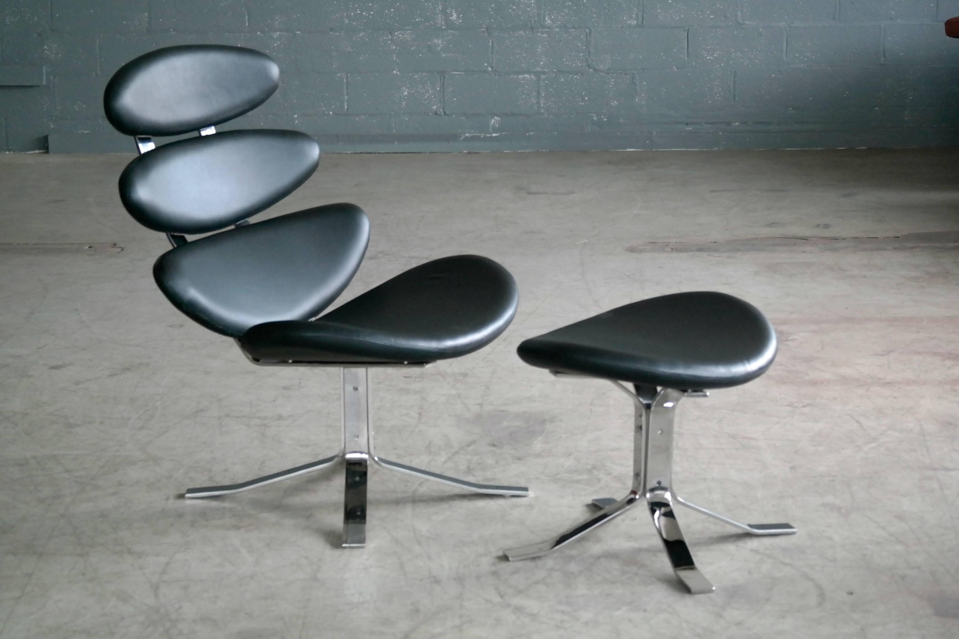 Replica of the famous Corona chair with ottoman icon of Madmen glory in black leather and steel. The Corona chair designed in 1958 way ahead of its time by Poul M. Volther and originally manufactured by Erik Jørgensen Møbelfabrik A/S as Model EJ 5.