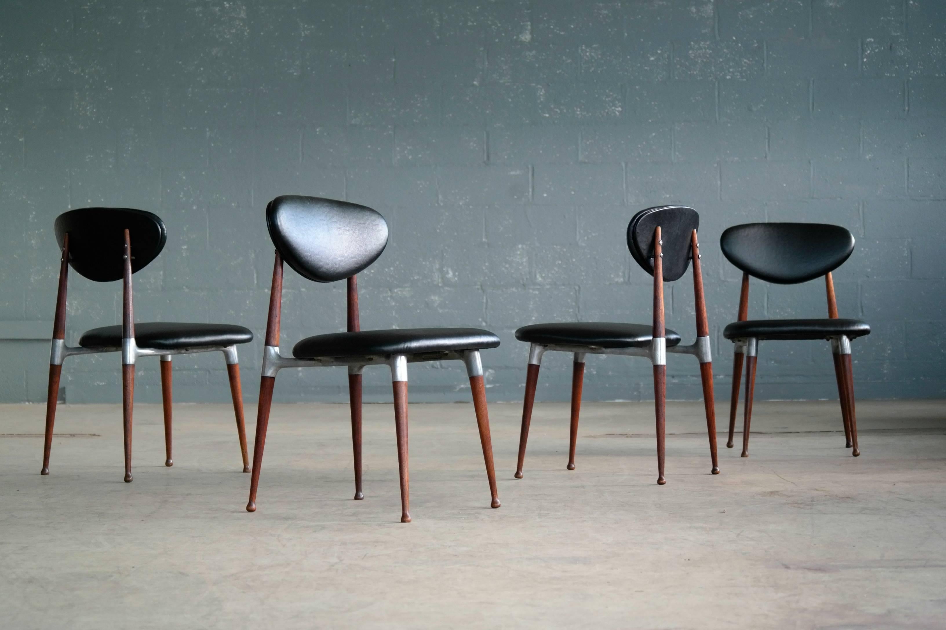 Modern and elegant set of four dining chairs designed in the 1960s by Dan Johnson for Shelby Williams. Manufactured in turned walnut and cast aluminum the chairs offer a very sophisticated almost delicate design expression. Just superb. Excellent