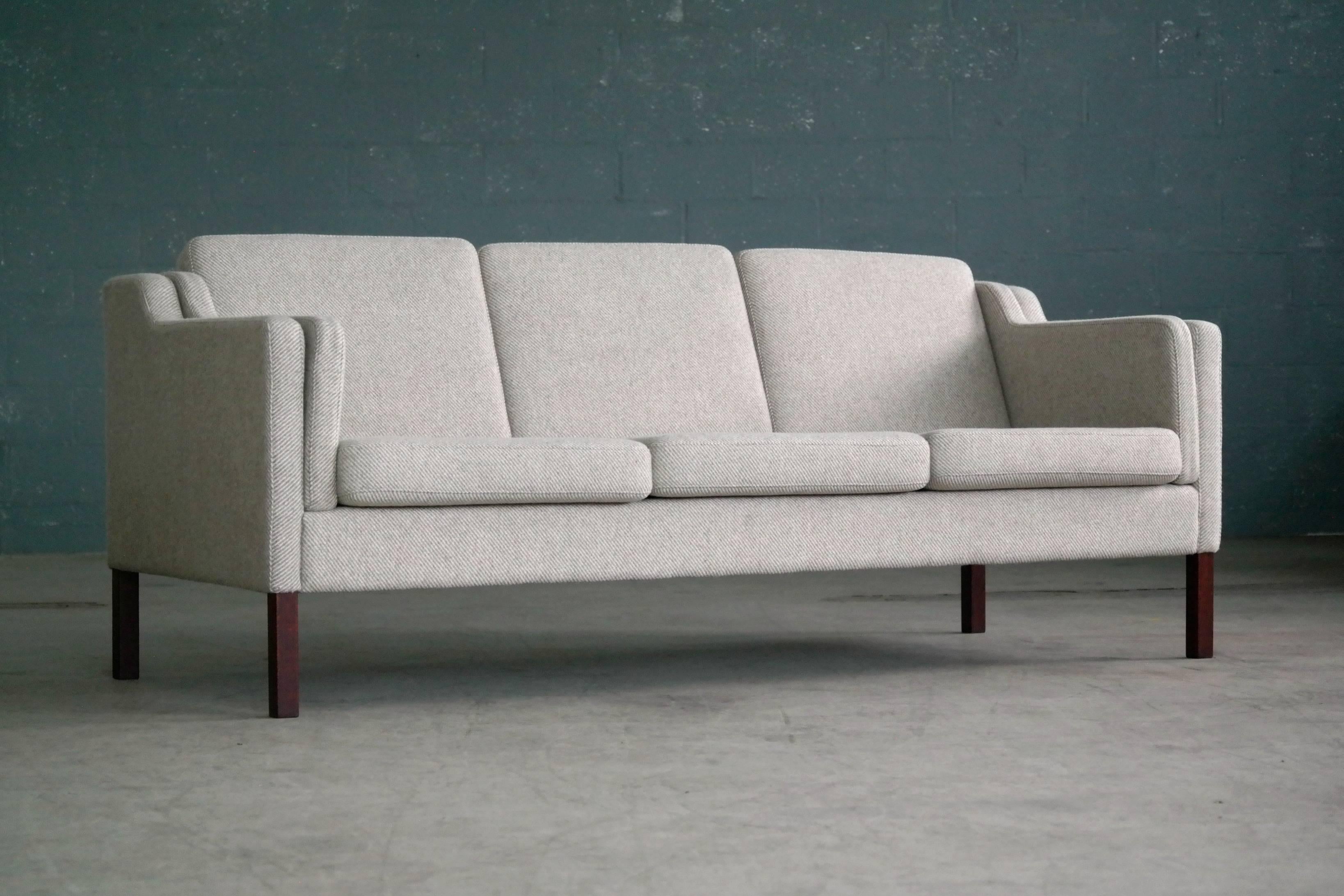 Beautiful three-seat London, sofa in style of Borge Mogensen's famous model 2213 covered in a high quality grey wool raised on stained beech legs. This style sofa originally called a London sofa when first designed by Borge Mogensen is probably one