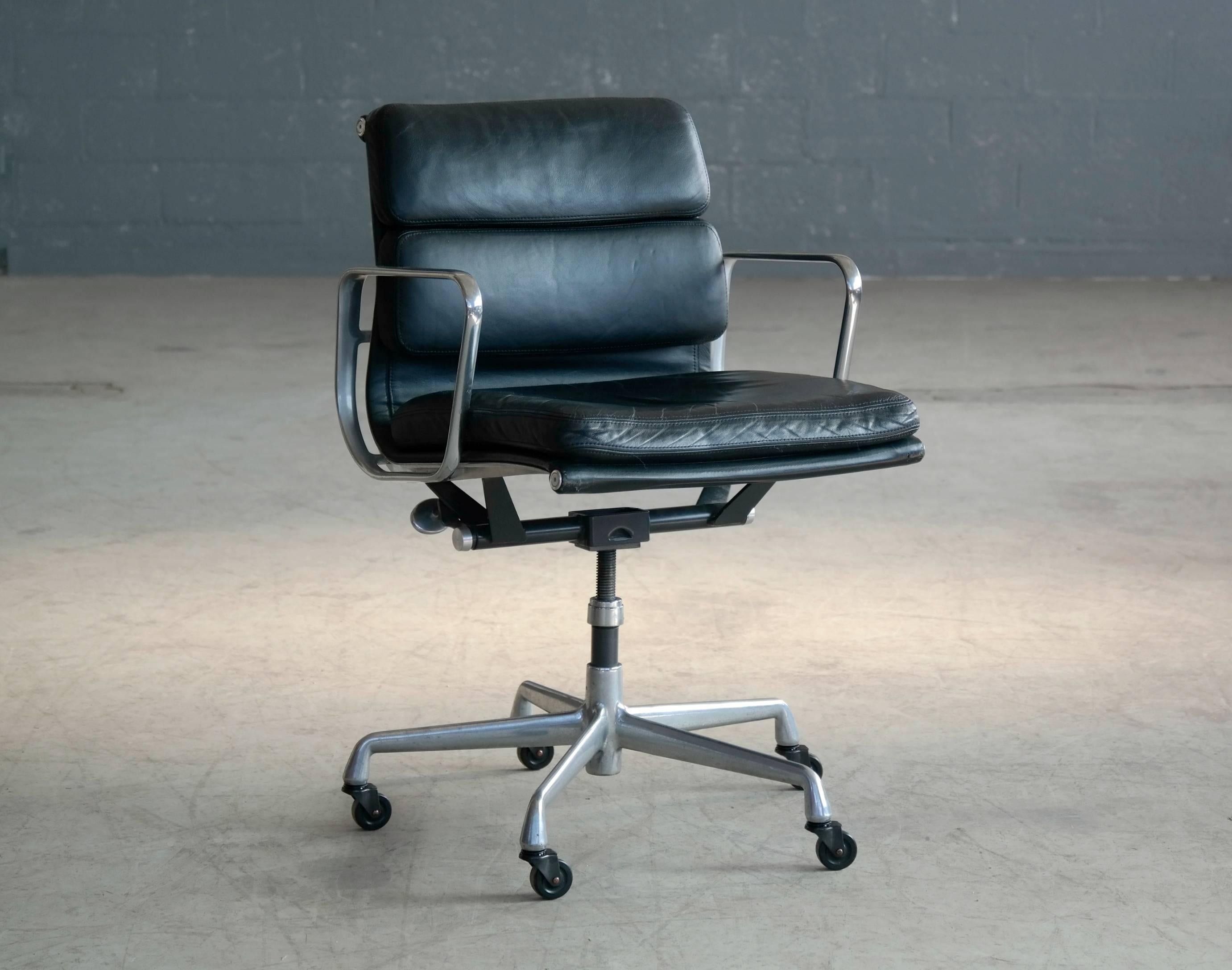 Classic Soft Pad Management chair by Ray and Charles Eames. Supple black leather and chromed aluminum with caster wheels and adjustable seat. This is the European model made by ICF under license from Herman Miller. The European model distinguishes
