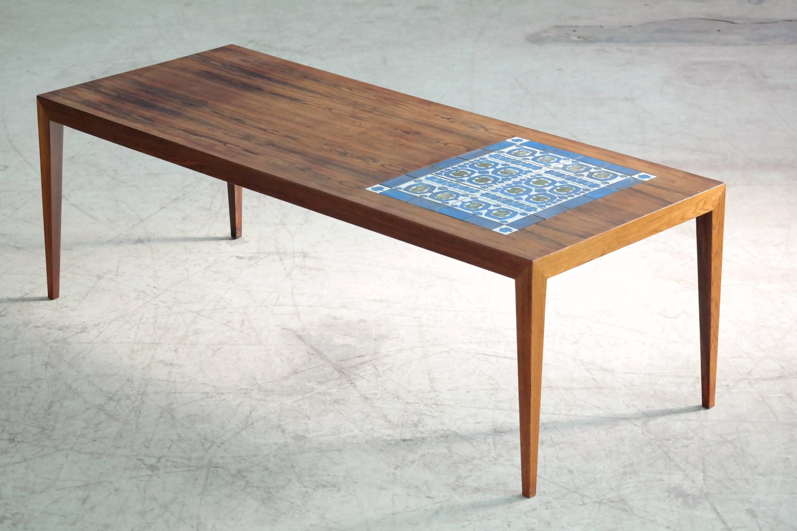 Beautiful rosewood coffee table by Severin Hansen Jr. for Haslev with inlaid tiles designed by Grethe Hellan Hansen and manufactured by Royal Copenhagen. Haslev's coffee tables epitomizes minimalist elegance with its sharp lines and iconic diamond