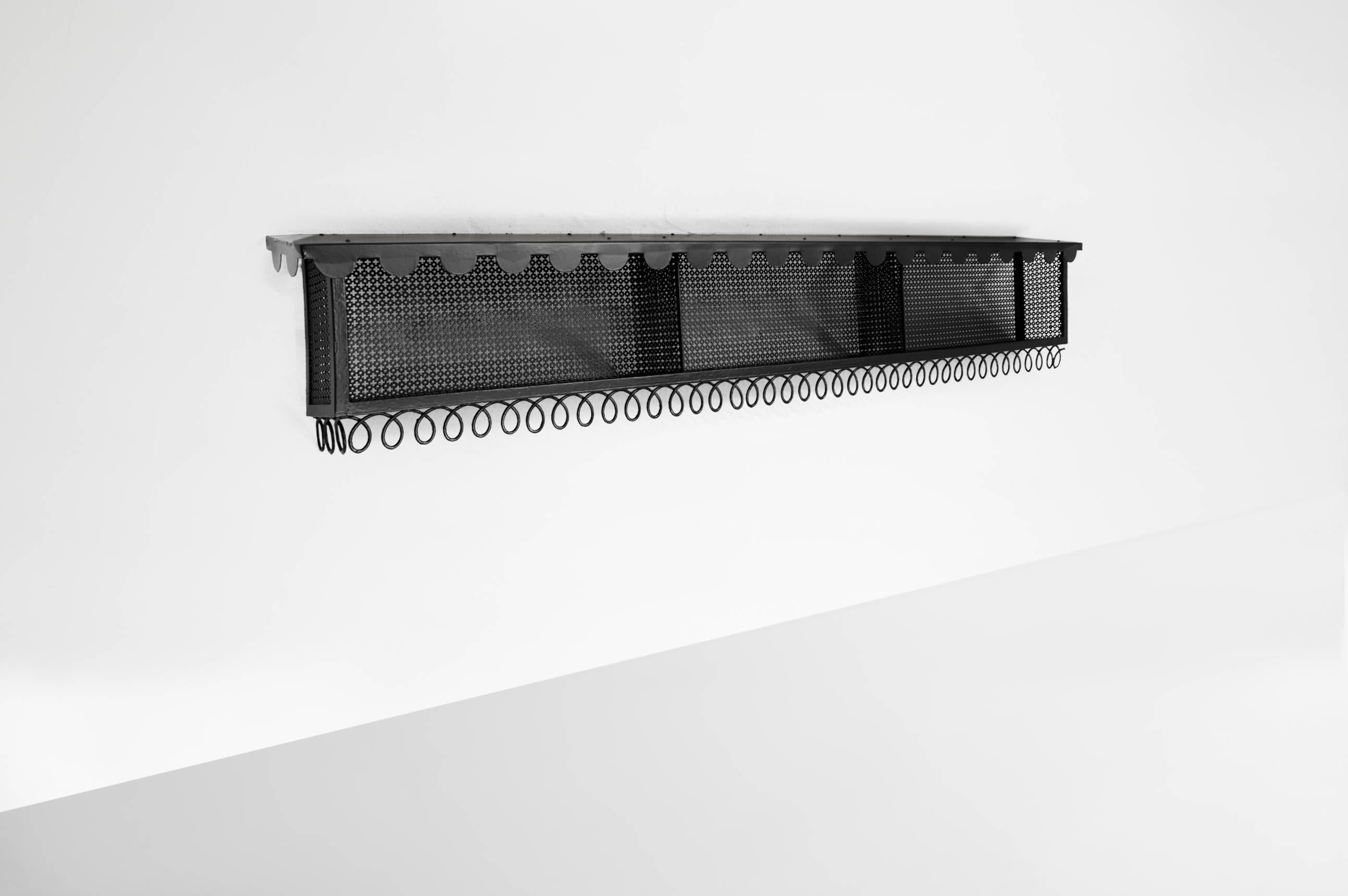 Mathieu Matégot (1910-2001).

Wall mounter bookshelf.
Manufactured by Atelier Mategot,
France, 1960.
Lacquered and perforated metal.

Measurements:
200 cm x 38 cm x 48 H cm.
78.74 in x 15 in x 19 H in.

Provenance:
A hair salon in Paris