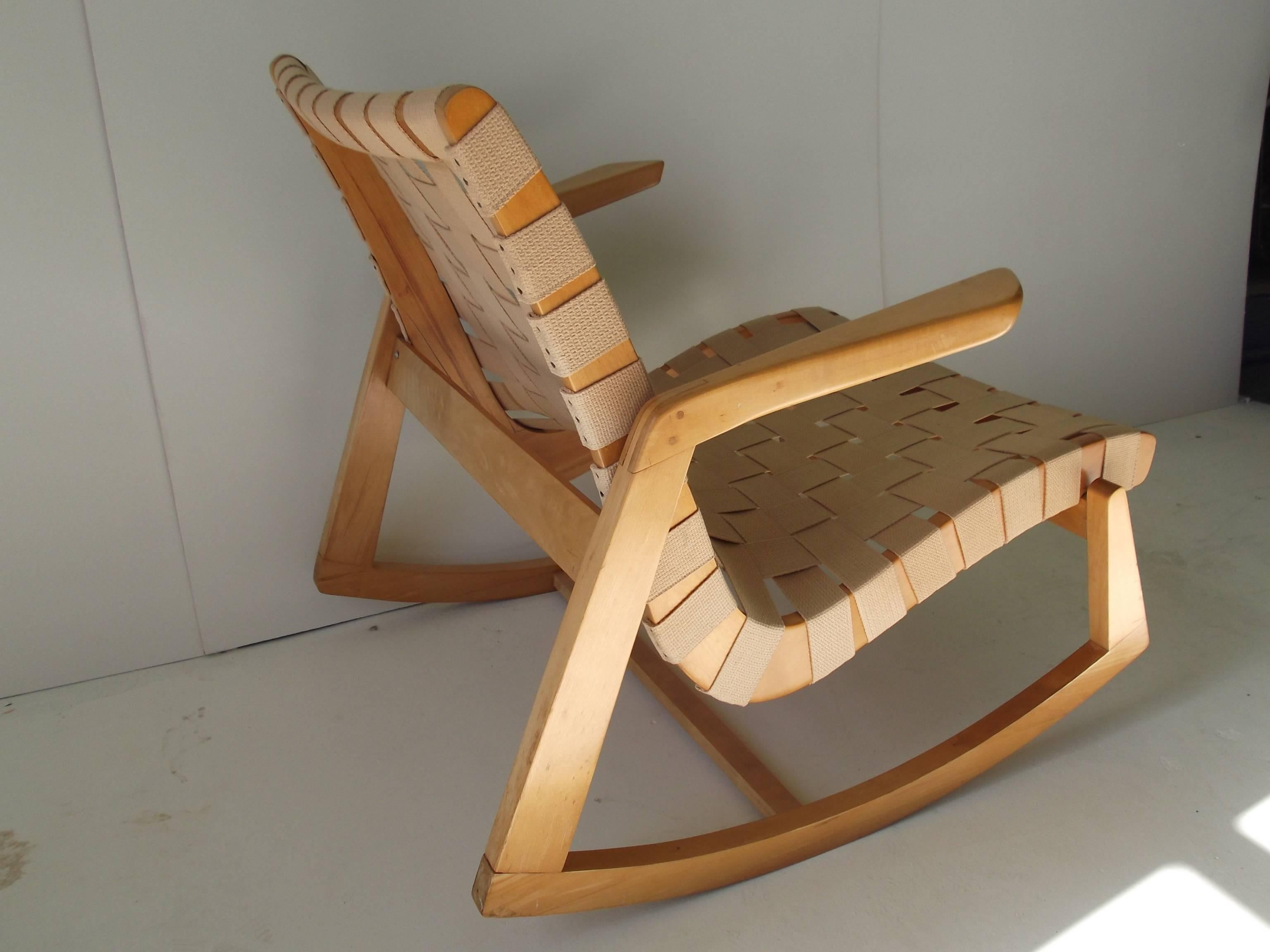 This is an early beautiful condition birch frame rocking chair designed by Ralph Rapson for Knoll, in 1945. An early version of this piece is fairly scarce, as not many have survived, due to their delicatness. It has a cotton webbed seat and back.