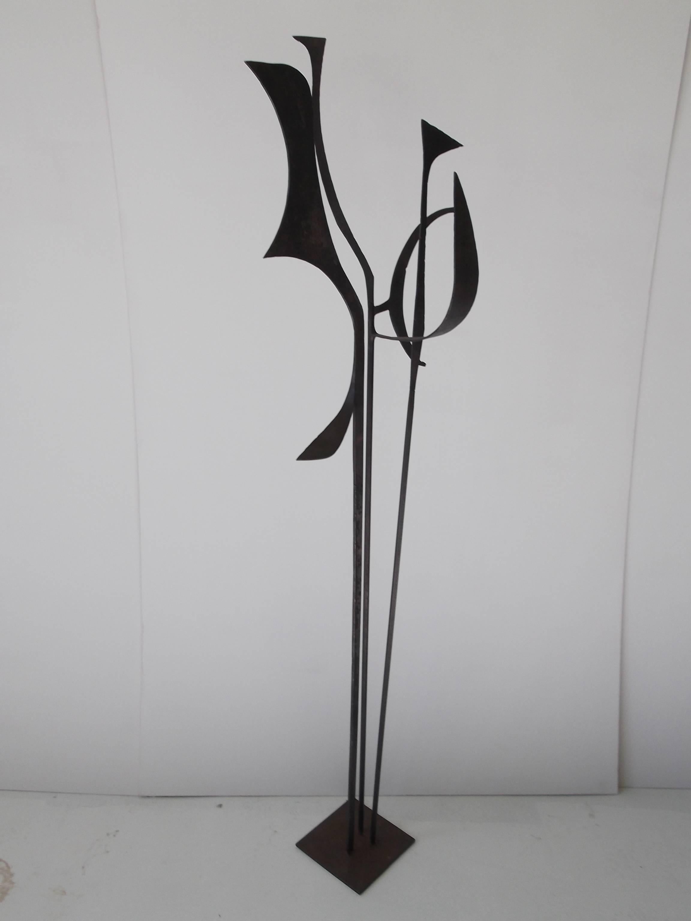 This is a dramatic modernist steel sculpture, made by well listed Oklahoma artist, Jay J. McVicker. It is a nice vertical piece that won't take up a lot of floor space, but delivers the wow! Standing 5.5 feet tall. It is artist singed to base with