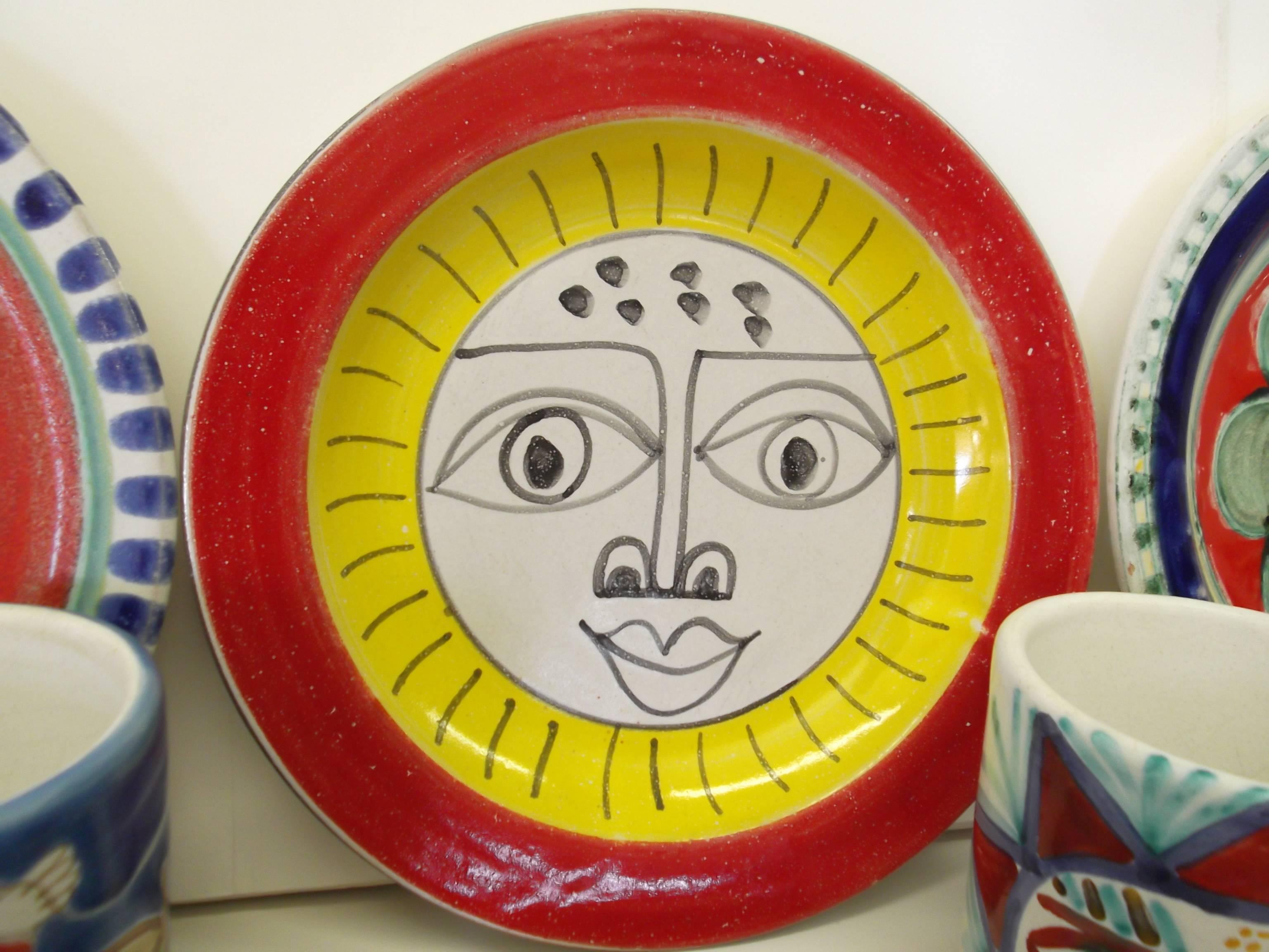 All 22 pieces are vintage, 1960s, and all are signed DeSimone. Included are: Six dinner plates, six lunch or salad plates, seven mugs, and three bowls. The graphics all vary from figural, to fish, to suns! One of the most fantastic and whimsical