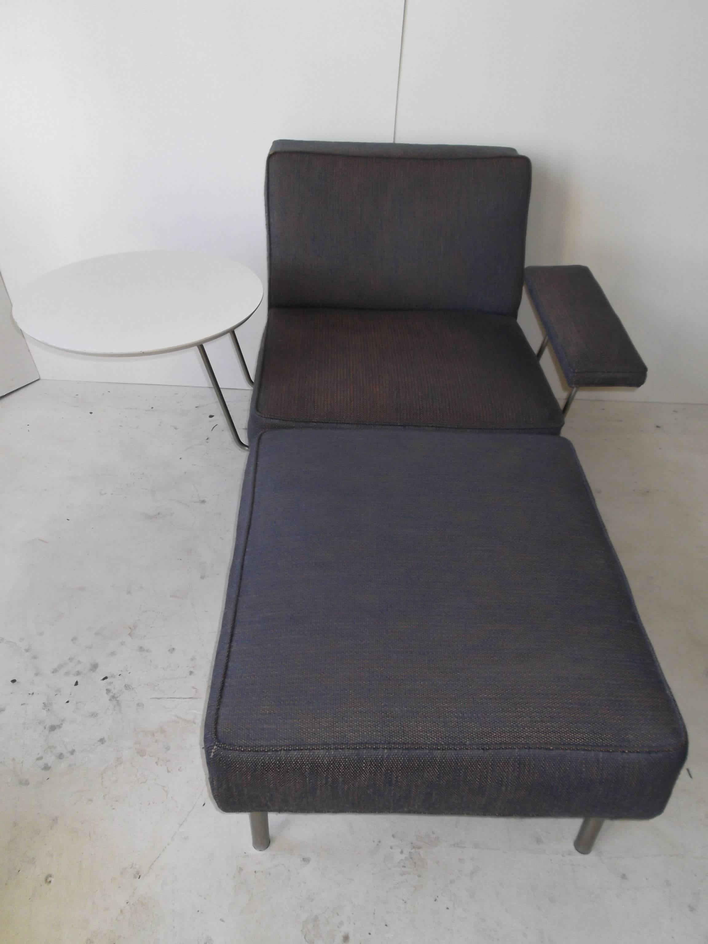 All original George Nelson for Herman Miller chaise longue. It features chair with tilting arm and rare tray table attachment. It also has the oversized ottoman that converts piece to a chaise longue. It is on spun metal legs. It also retains the