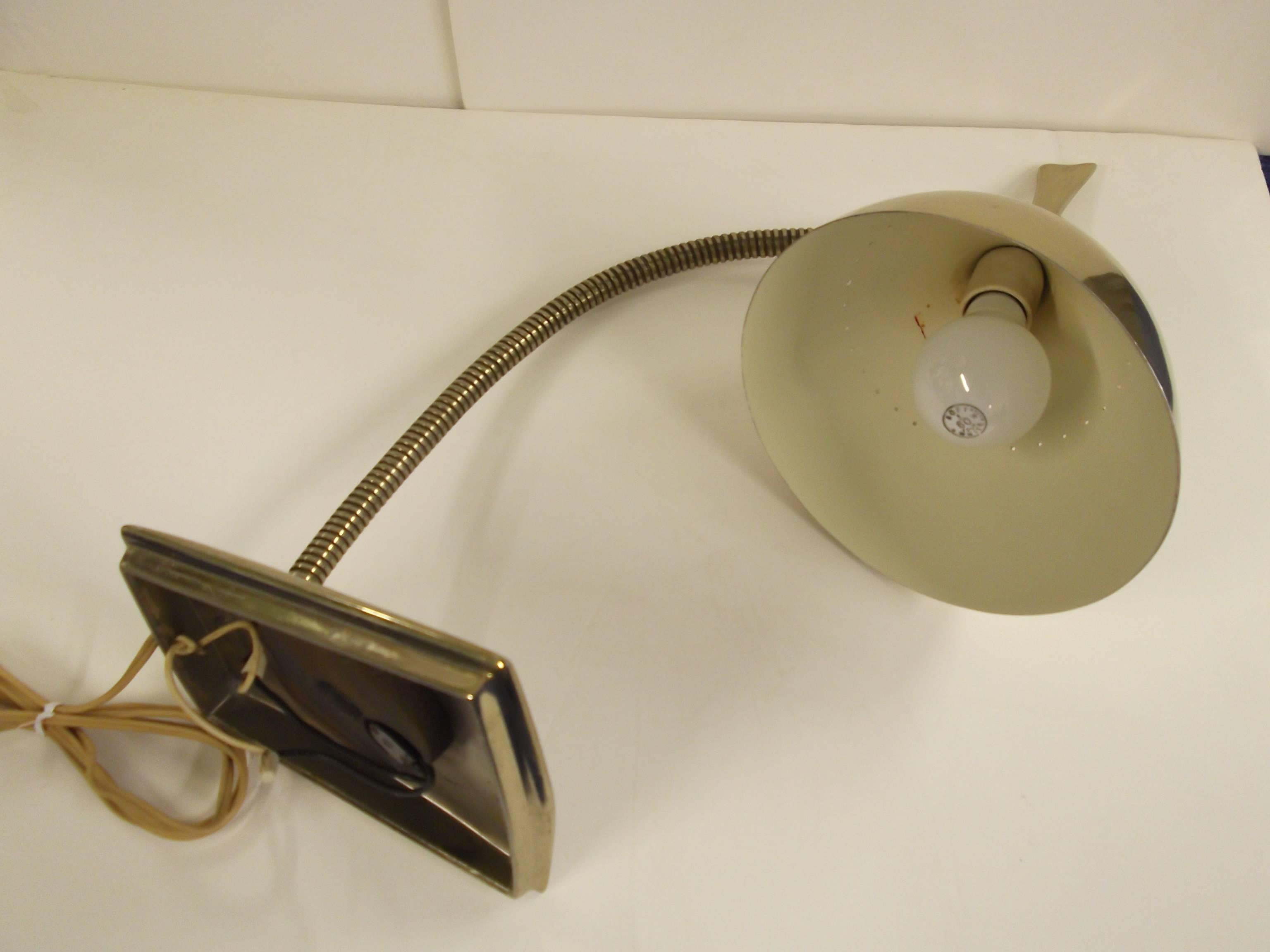 This is one of the hardest laurel desk lamps to find. It is in brass with an asymmetrical shade that has an extended flattened brass handle. The shade can pivot in any direction on a ball socket, even as an up light. The shade has a row of