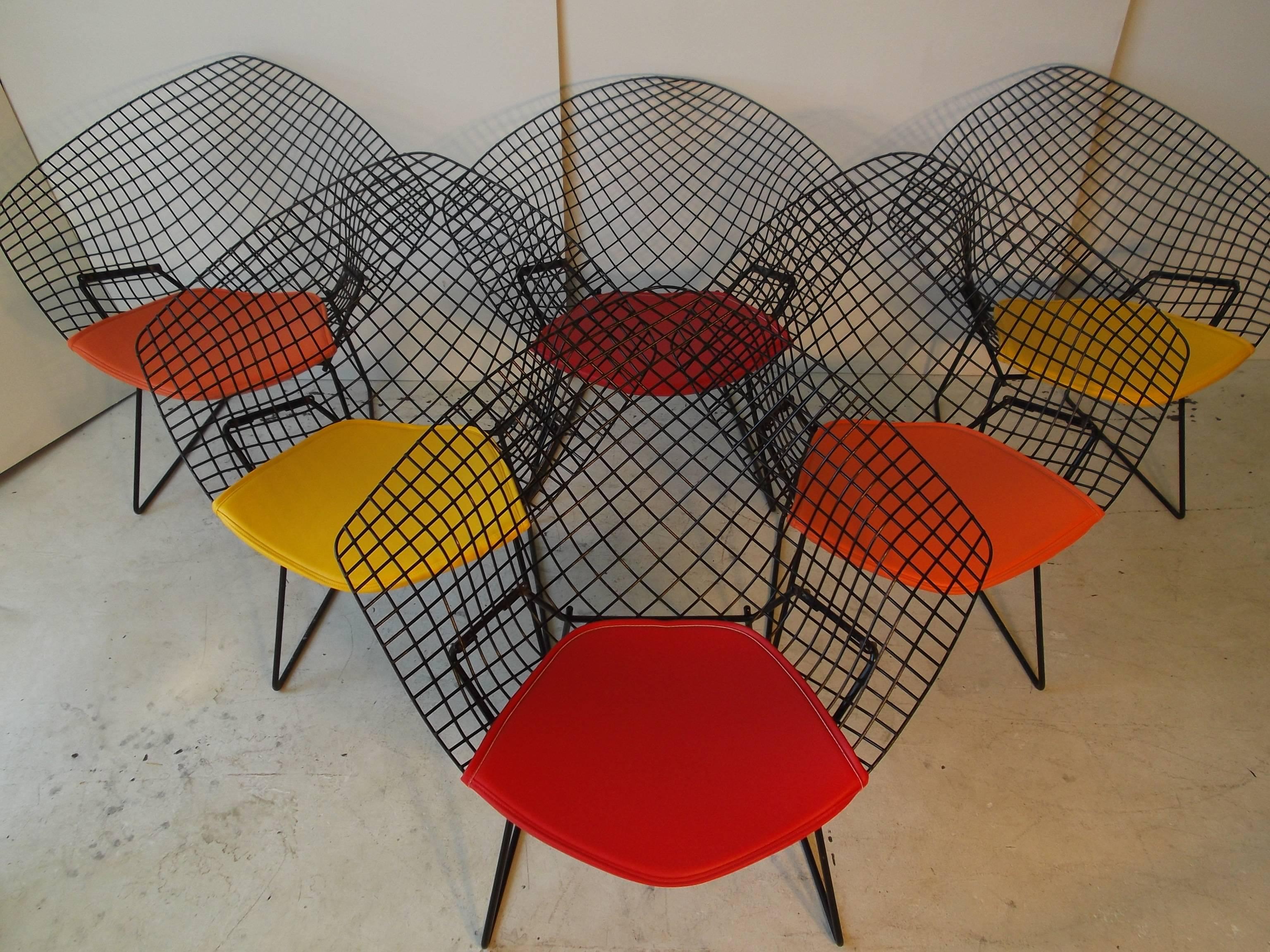 Price is for two chairs. I have available six vintage 1950s Harry Bertoia wire diamond chairs for Knoll, furniture. They have new pads, and are ready to go. Great outdoors or inside! These have old paint with some minor losses. Sold in Pairs with