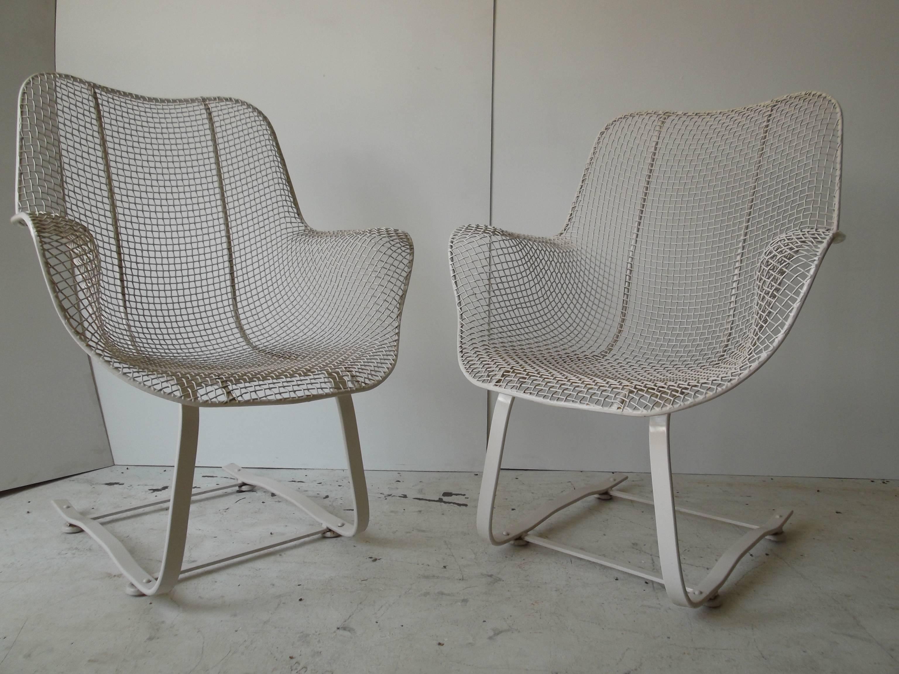 This is a very hard to find pair of Woodard Sculptura lounge chairs. They are the high back wire mesh lounges on Springer rocker bases. They are vintage from the 1960s. This is one of the best designs for Mid-Century Modern outdoor furniture by far.