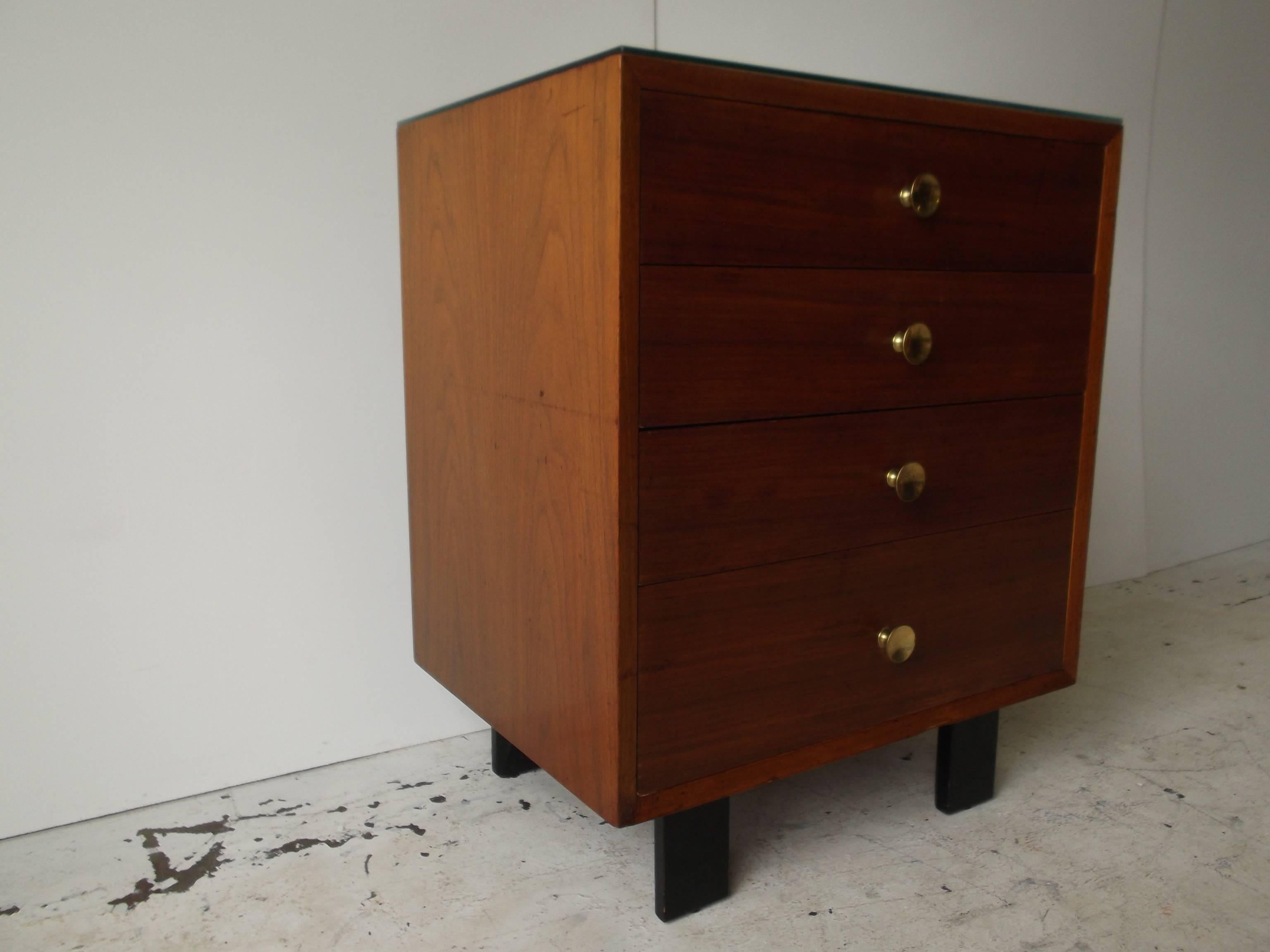 This is a nice George Nelson for Herman Miller small chest. It features four drawers, and is perfect as a nightstand. It also goes great at the end of a sofa. It has the early 1950s foil label intact to top drawer. It is very clean, but has some