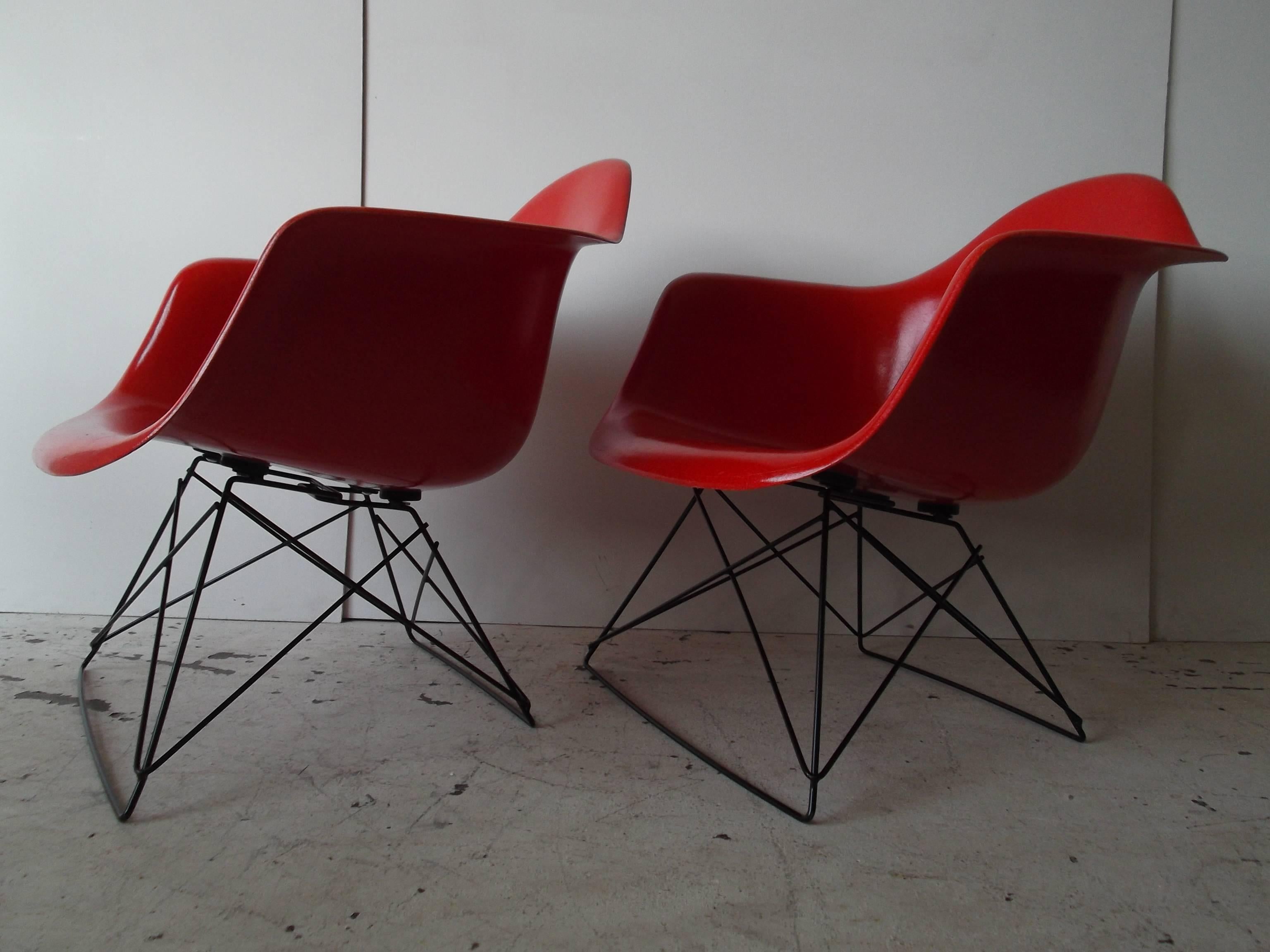 This is for a stunning pair of original Eames Herman Miller fiberglass shell armchairs. The chairs are in the hard to find true red. They each have the Herman Miller mark to bottom, with the Cincinnati Milicron mark from the 1960s. The chairs are