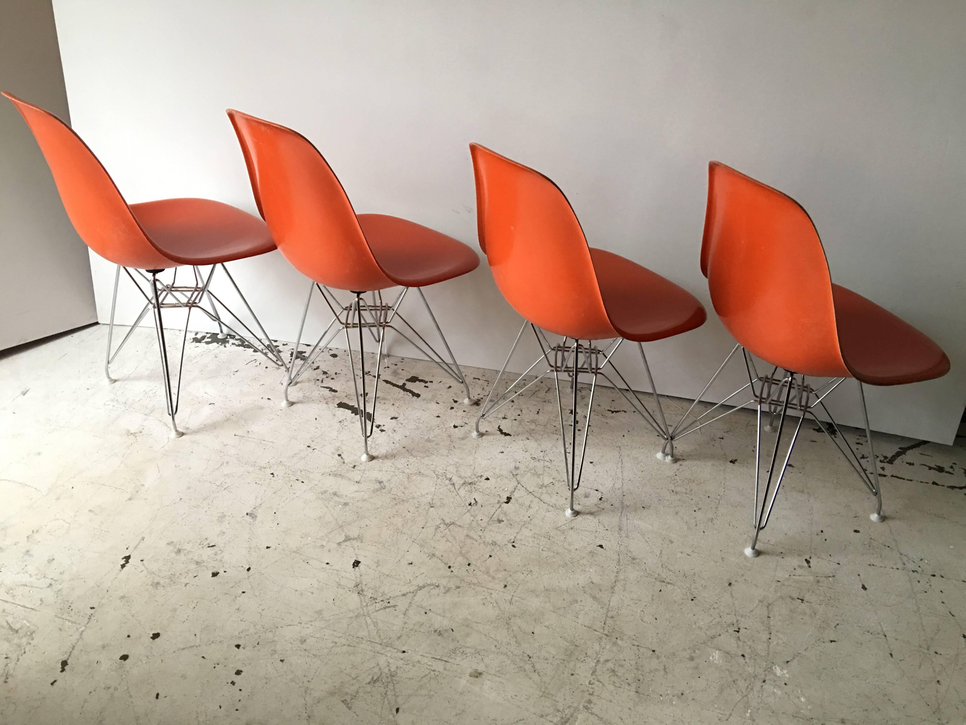 This is a nice set of vintage 1977 bright orange Eames, Herman Miller fiber glass chairs, on new production Chrome Eiffel Tower bases. Chairs fully marked with Herman Miller Cincinatti Milicron logo, in Great shape, few scratches as pictured.