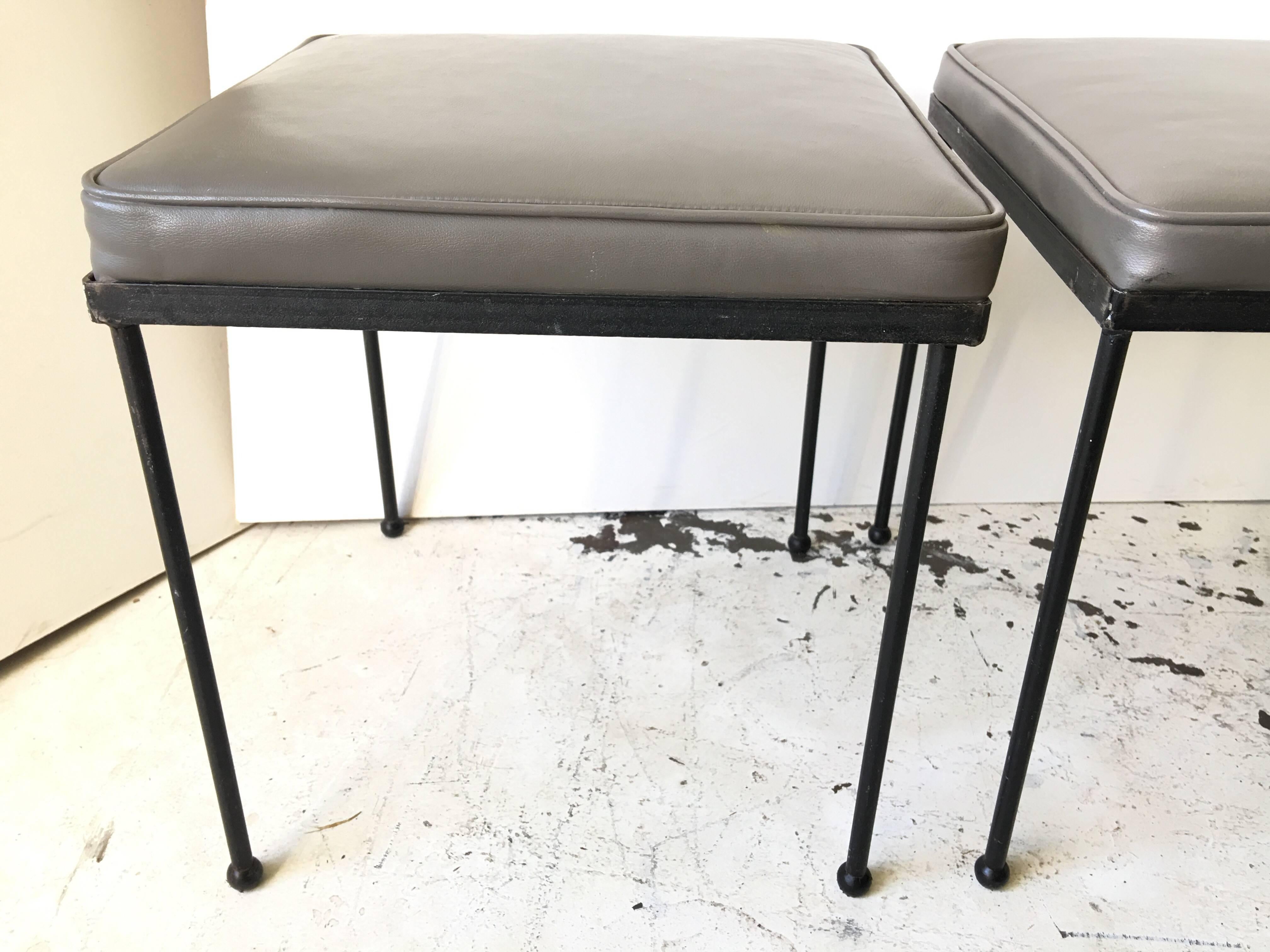 From a famed Mid-Century Modern artist, designer. Set of three iron and original vinyl stools, from the 1950s. All ball feet intact and upholstery free from tears.