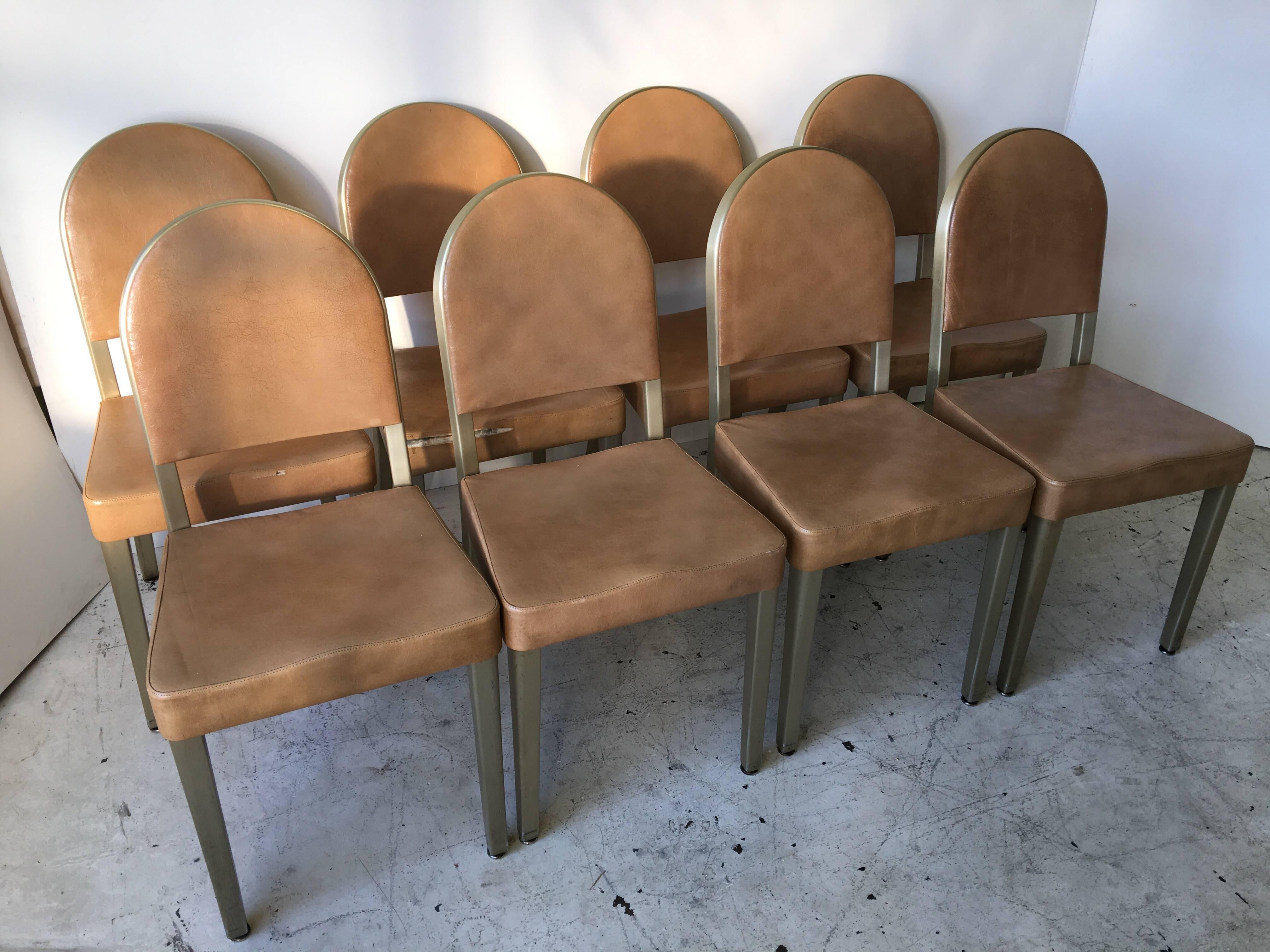 I am selling these as a set of eight. They are elegant in form with rounded backs coming off the Art Deco era. They have brushed aluminum frames, in a very faint bronze tone. They all retain original General Fireproofing and GoodForm Labels. They