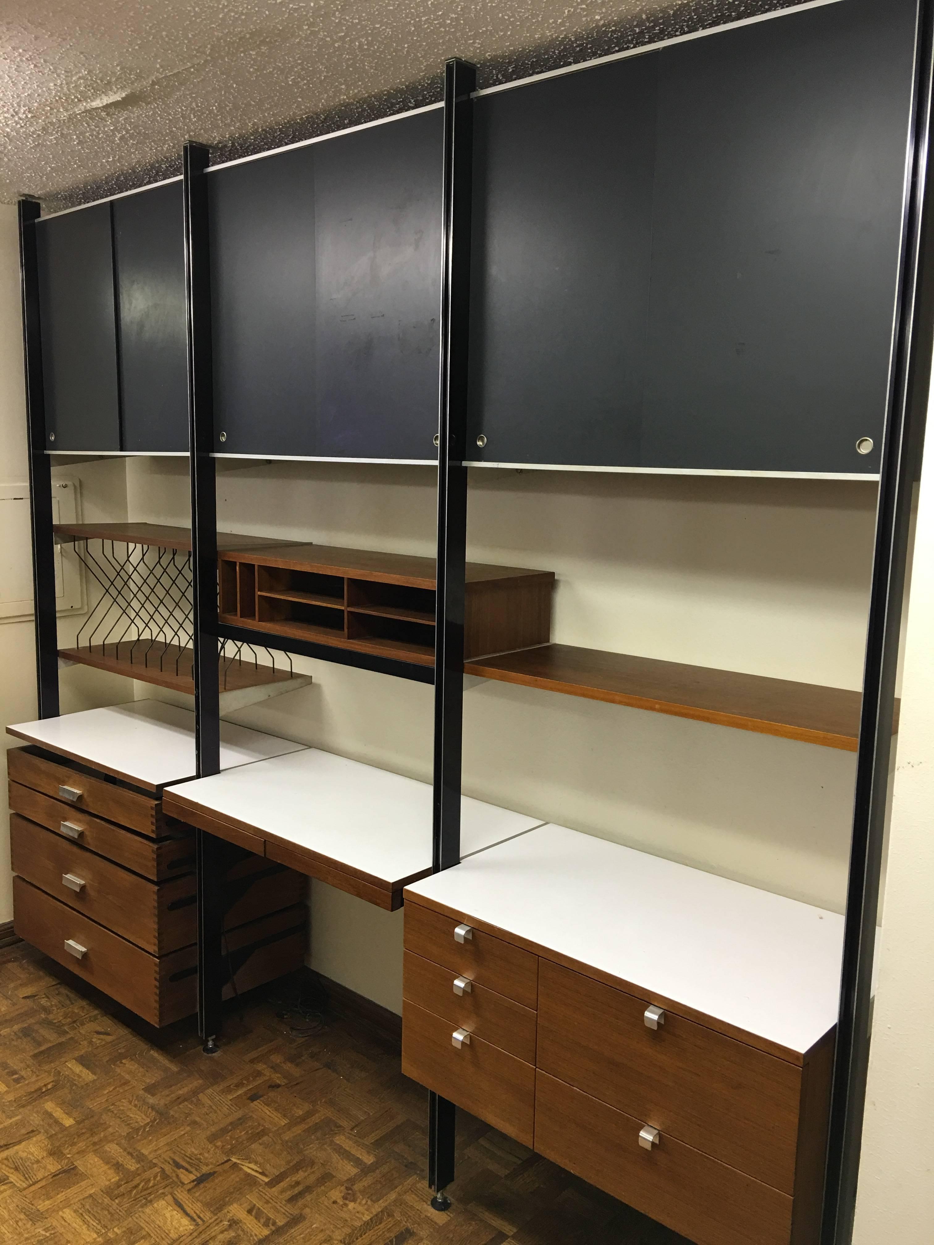 This is an exceptional example of a George Nelson CSS Unit. It has all the bells and whistles! There are three sliding door cabinets across top with shelves within, and also side cover panels, so they are closed off. Top is solid for display to the