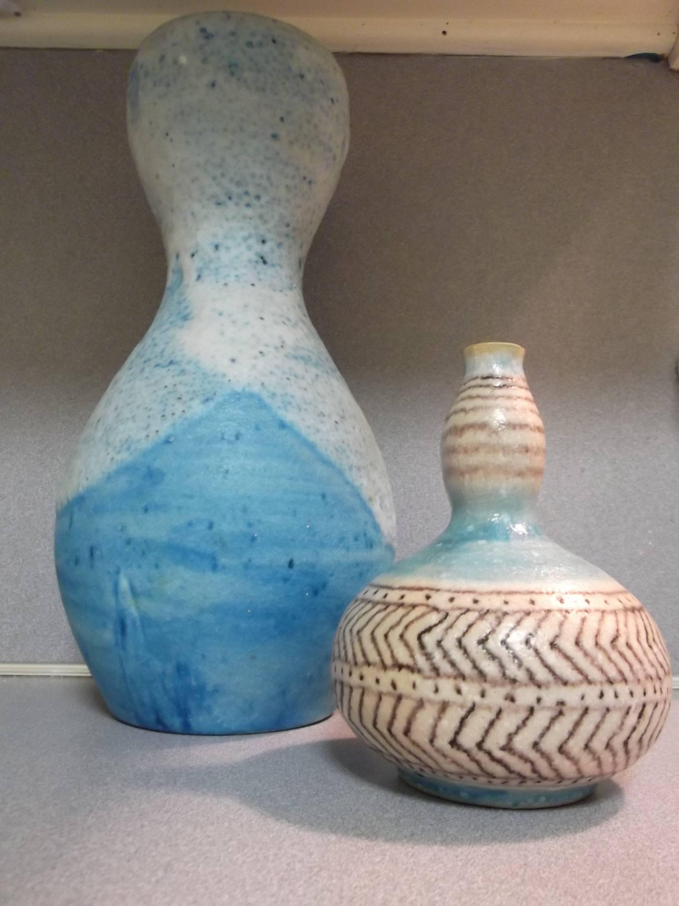 Two wonderful Italian pottery vases, both signed Gambone Italy, with the figural donkey mark. Both feature blue glazes, the smaller with purple striping. The larger has a bubbly lava thick white overcoat. The smaller measures 6