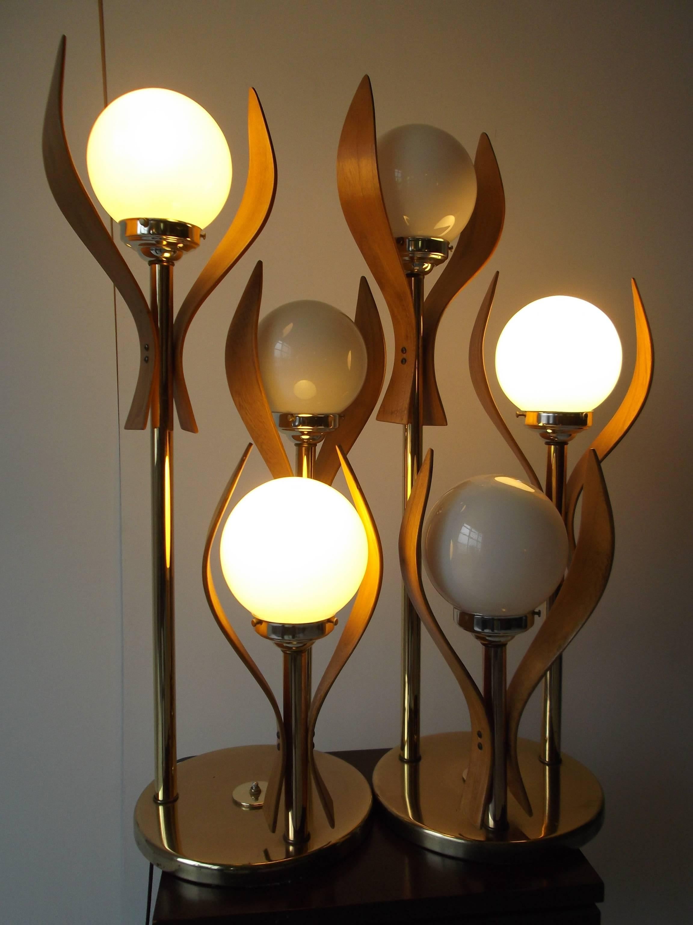 Pair of vintage unusual table lamps from circa 1970. They are in the form of abstract flowers, with bentwood leaves, on brass stems. They are amzzing in person and very sculptural. The switches are three-way, so you can have one lamp on, or the