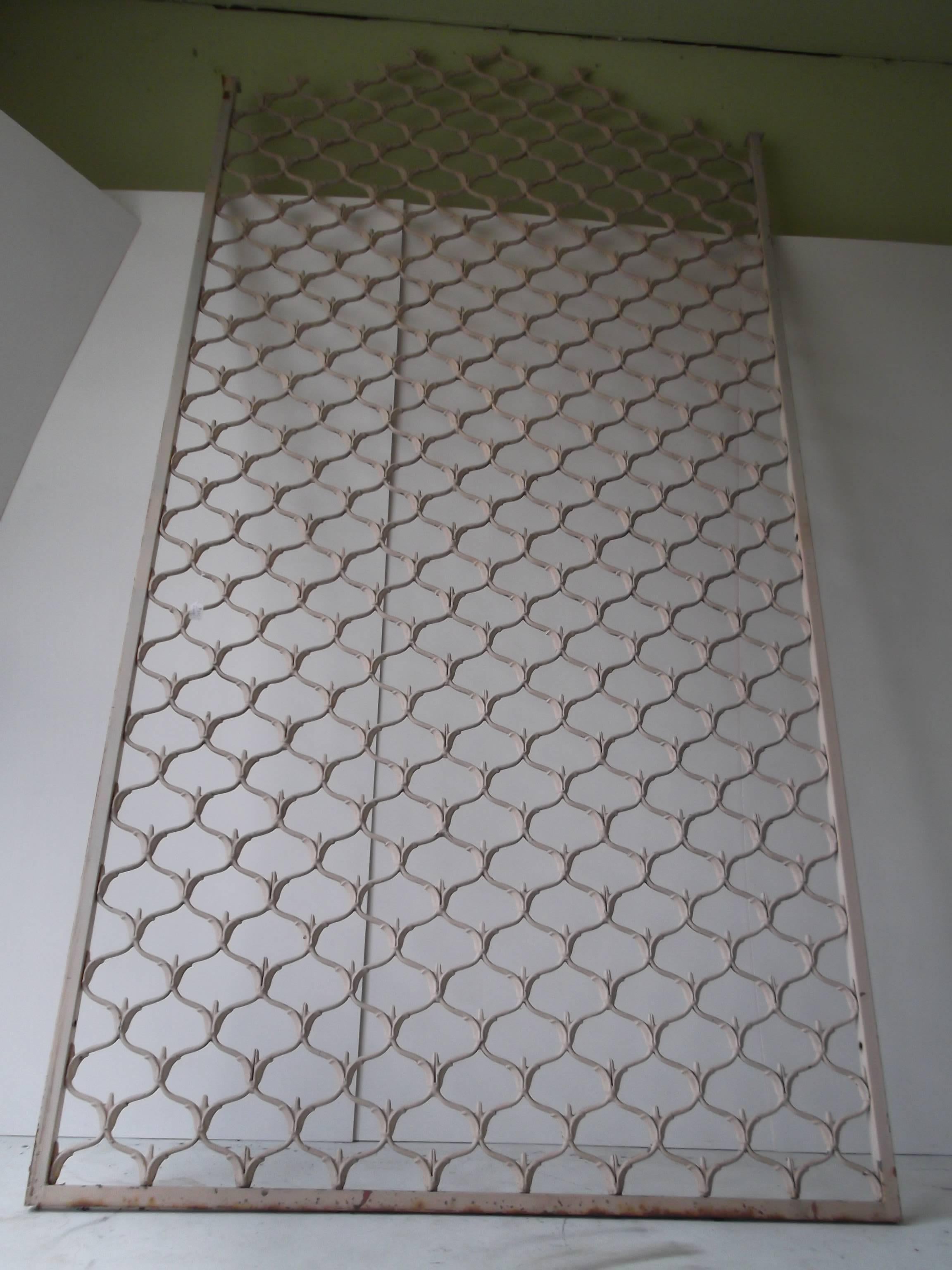 Cast metal grid, from the mid-20th century. It stands 10 feet 3 inches tall. Wow! The possibilities are endless. It would be great as a room divider, garden trellis, giant gate, and one suggested a Headboard for a bed. It has great design pattern to