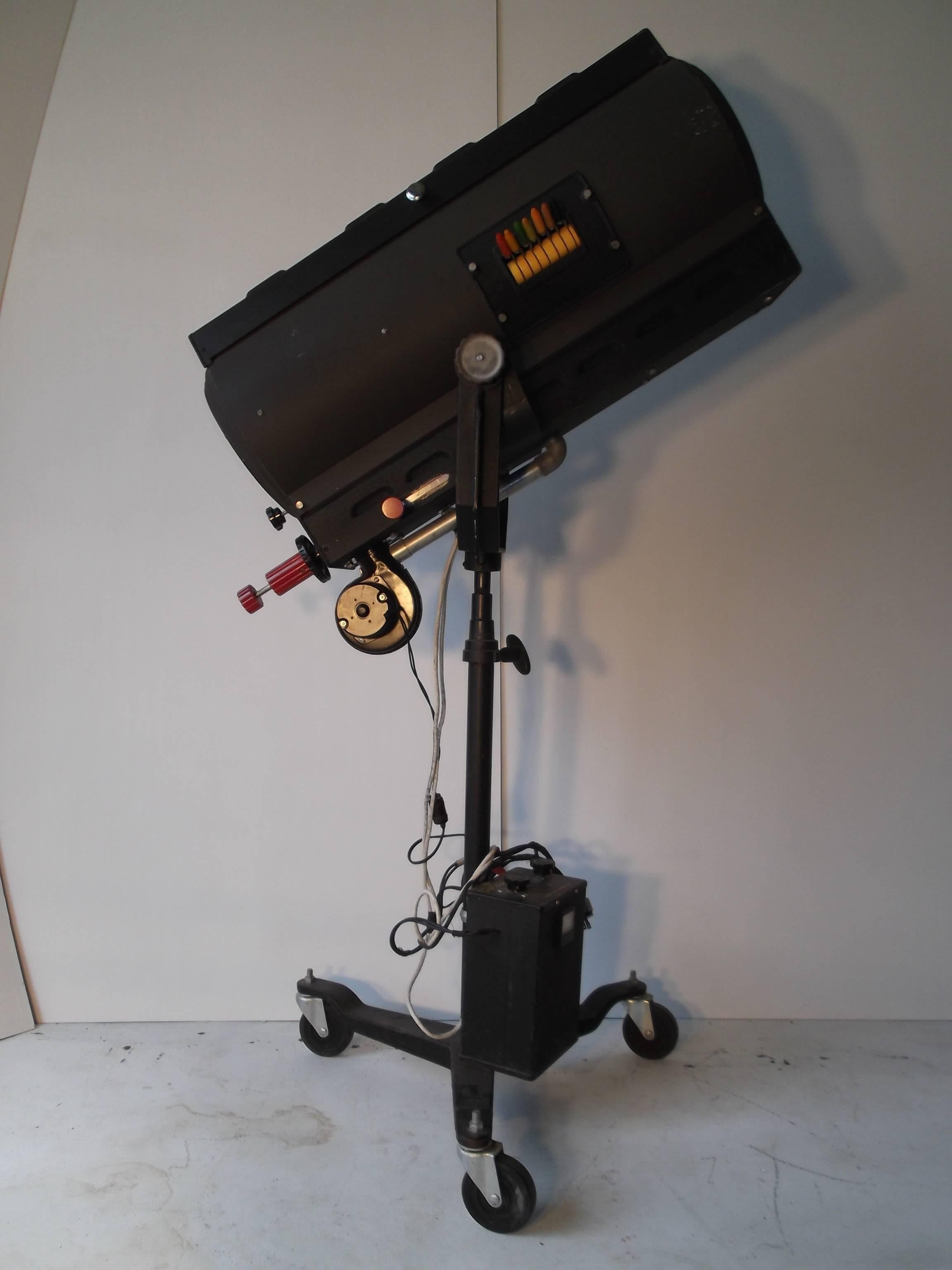 Major Equipment Company of Chicago produced this beauty, circa 1940s or 1950s. It is a dramatic spotlight for a stage production out of a theater, or a movie set. It comes on a rolling base, can be adjusted to about any angle! It has bakelite