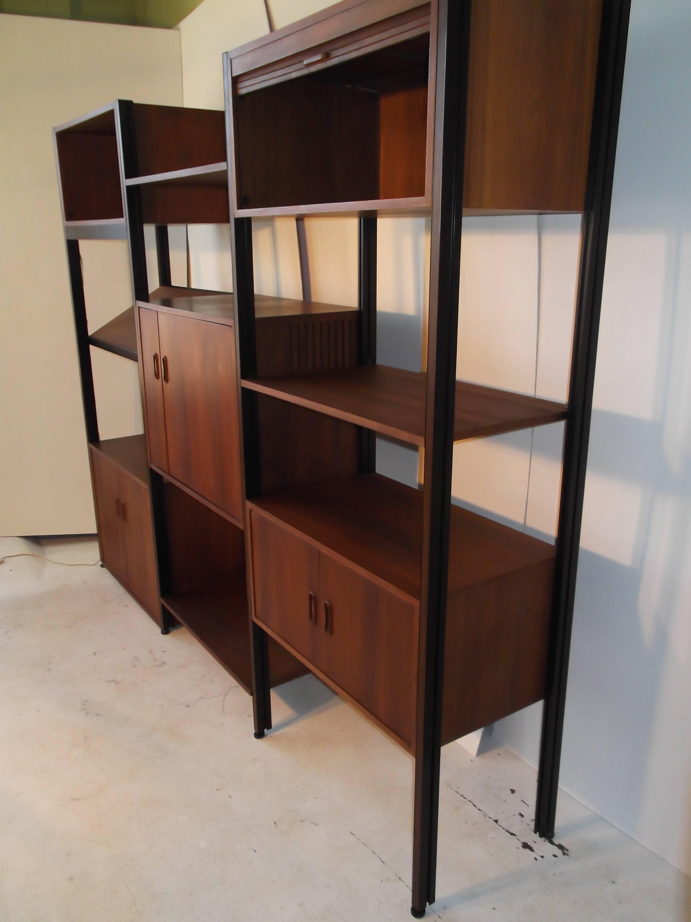 This is a wonderful version of the George Nelson Omni freestanding wall unit. It is super clean with gorgeous grain oiled walnut! It has many cases included. It has the rare stereo cabinet also that has a pull out turntable shelf. Included pcs: Open