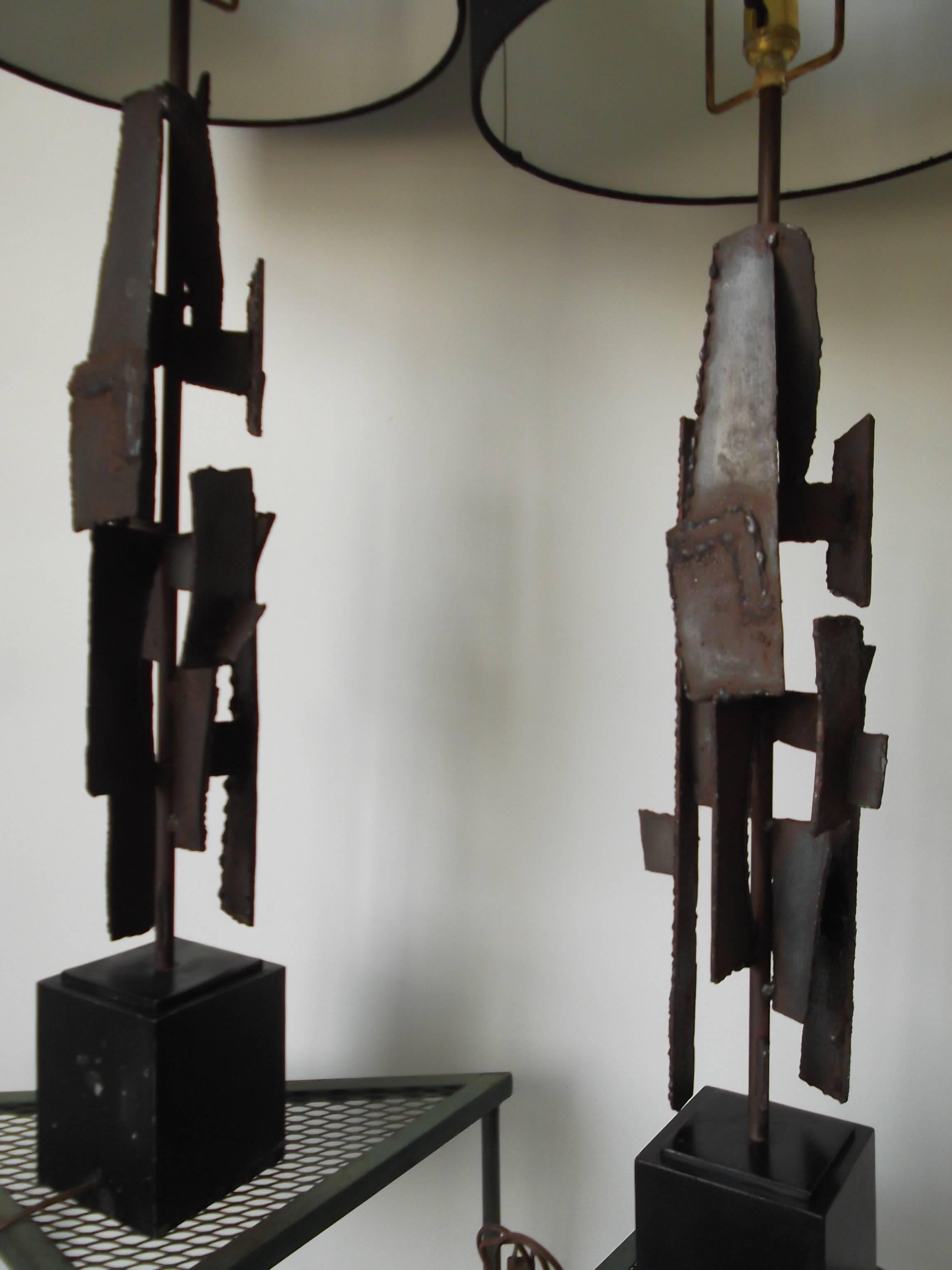 This is a fantastic Brutalist pair of torch cut, welded heavy steel, sculptural lamps. They are by Harry Balmer for Laurel Lamp Co., circa 1970. They are handmade and you can tell by the variations in sizes of the steel, although, they have the same