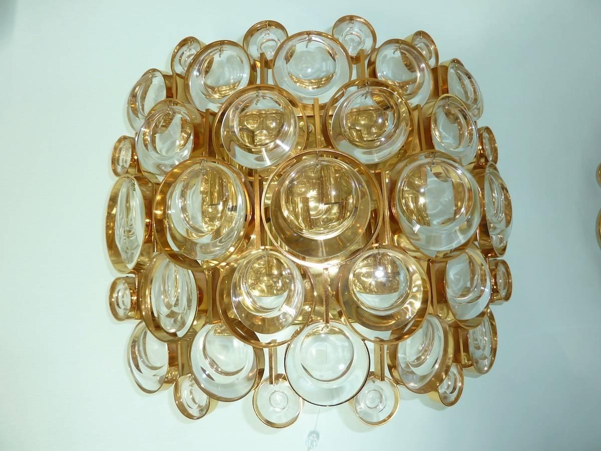 A pair of beautiful wall lights by Palwa, Germany, manufactured in Mid-Century, circa 1970s. They are made of gold-plated brass and small, medium and large round lens glasses. Very rare in this large size. Sold as a pair only. Excellent addition to